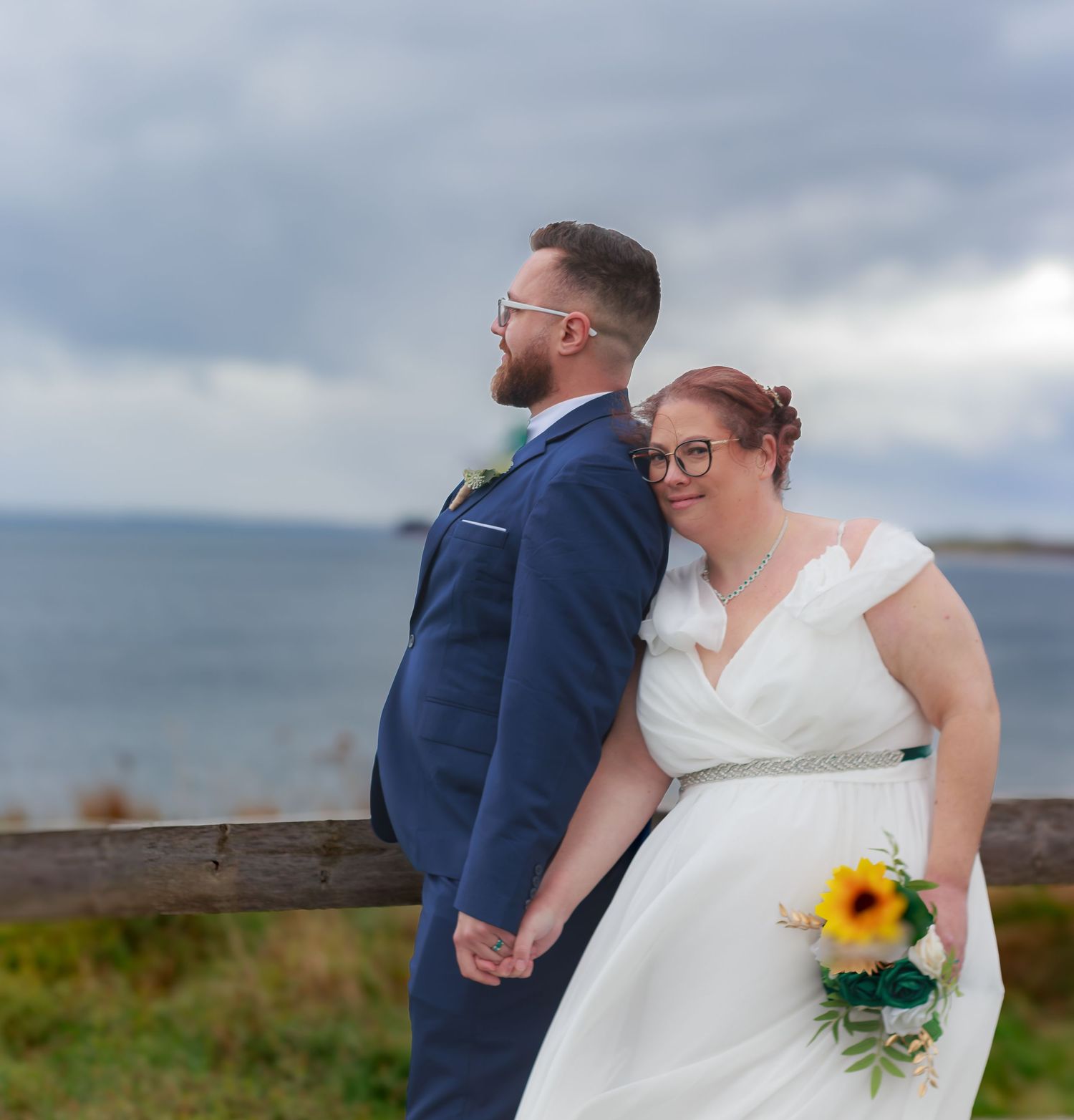 Newlyweds share intimate moments during their coastal wedding photoshoot.