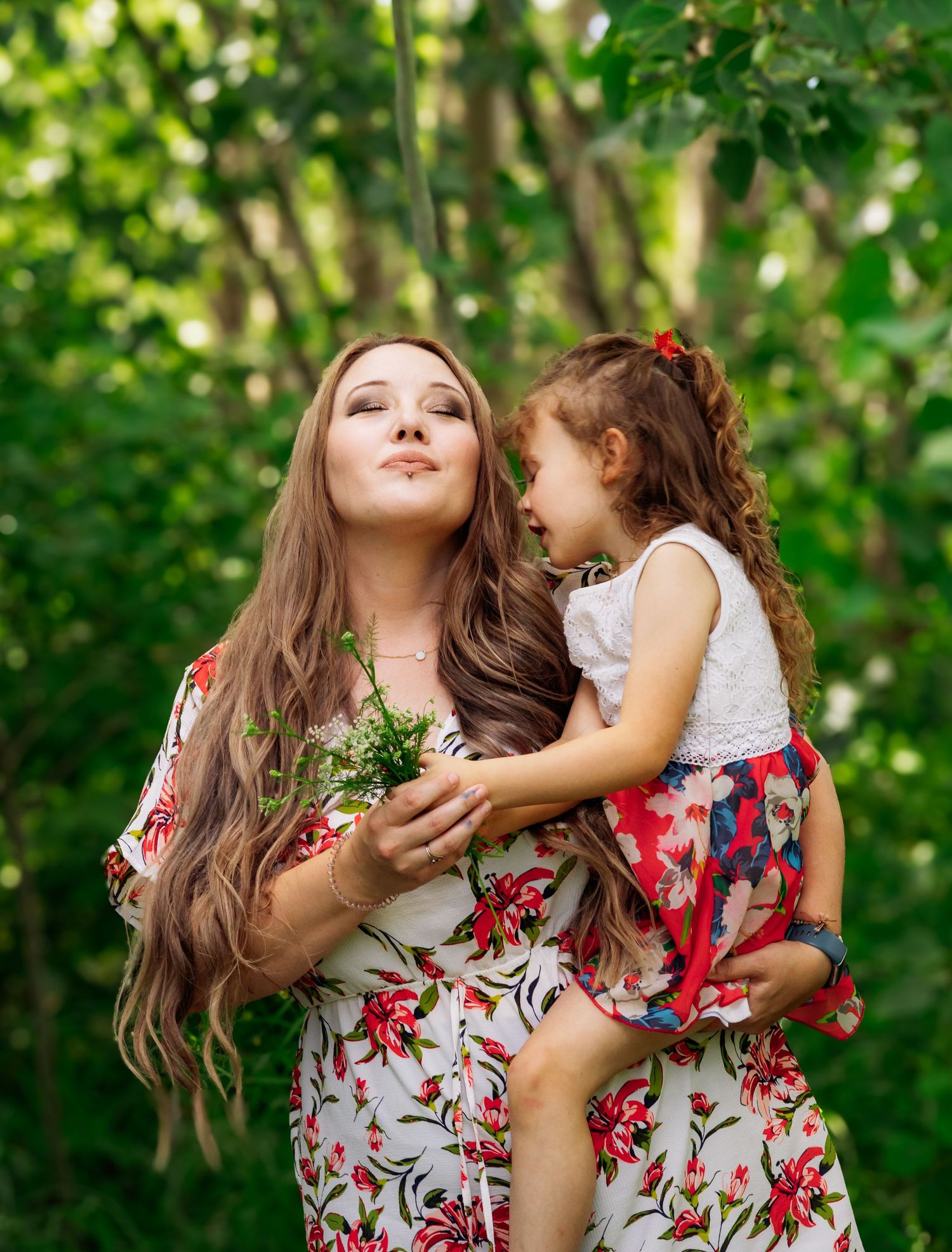 A sweet candid moment captured in a garden with matching floral print outfits.