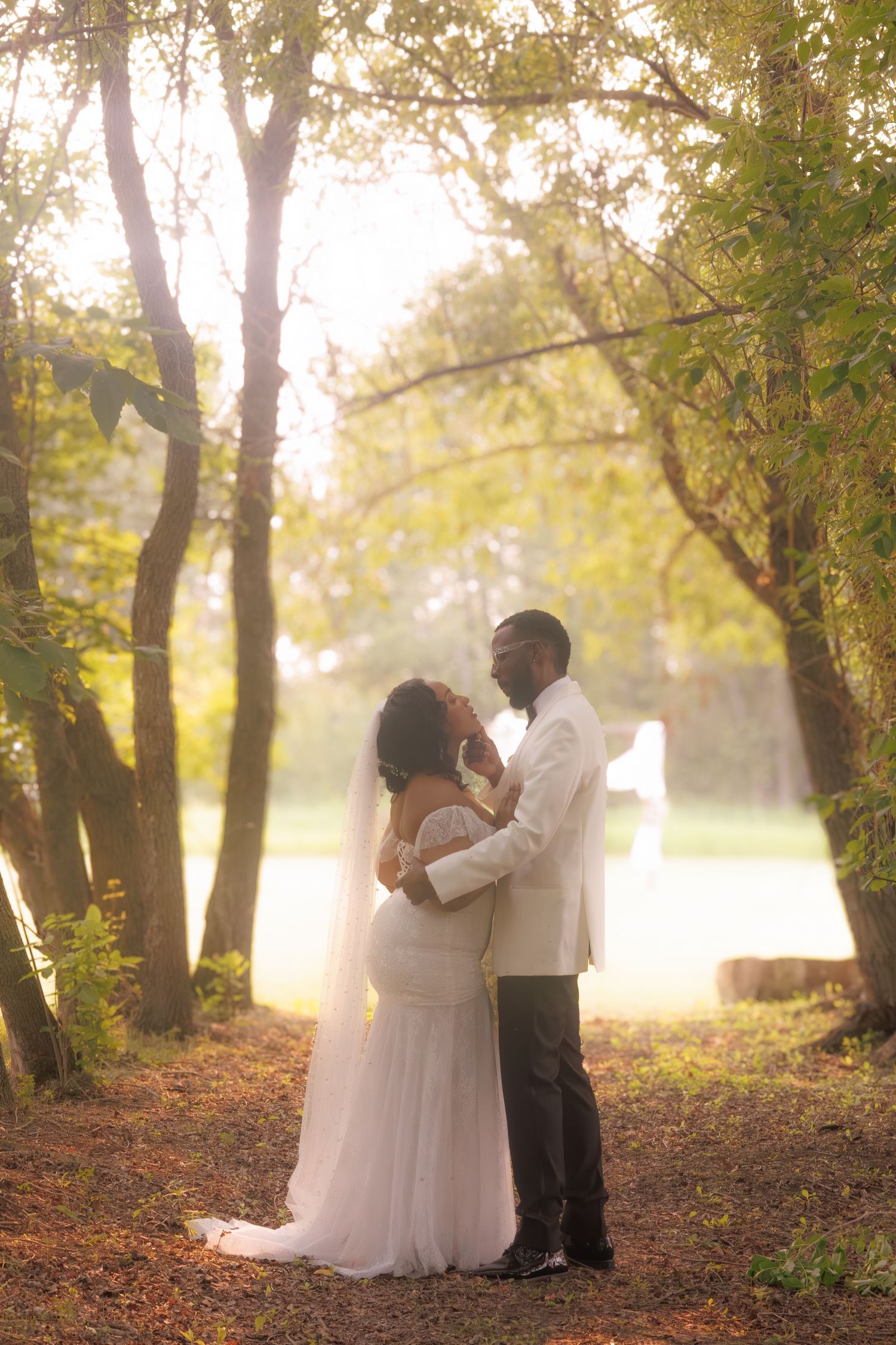 A romantic autumn wedding photoshoot among misty trees with golden sunlight.