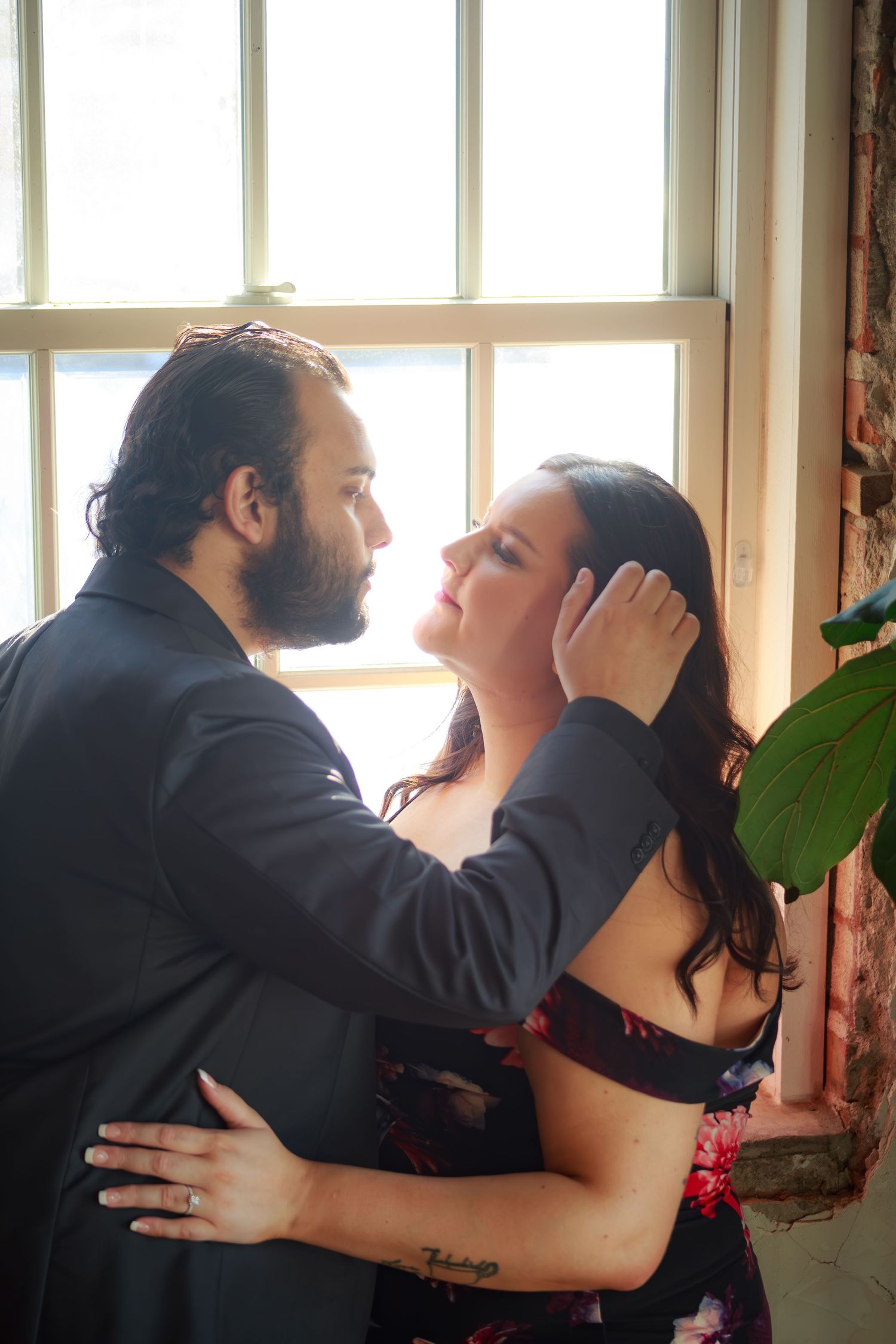 Romantic dance sequence near sunlit windows in an elegant indoor setting.