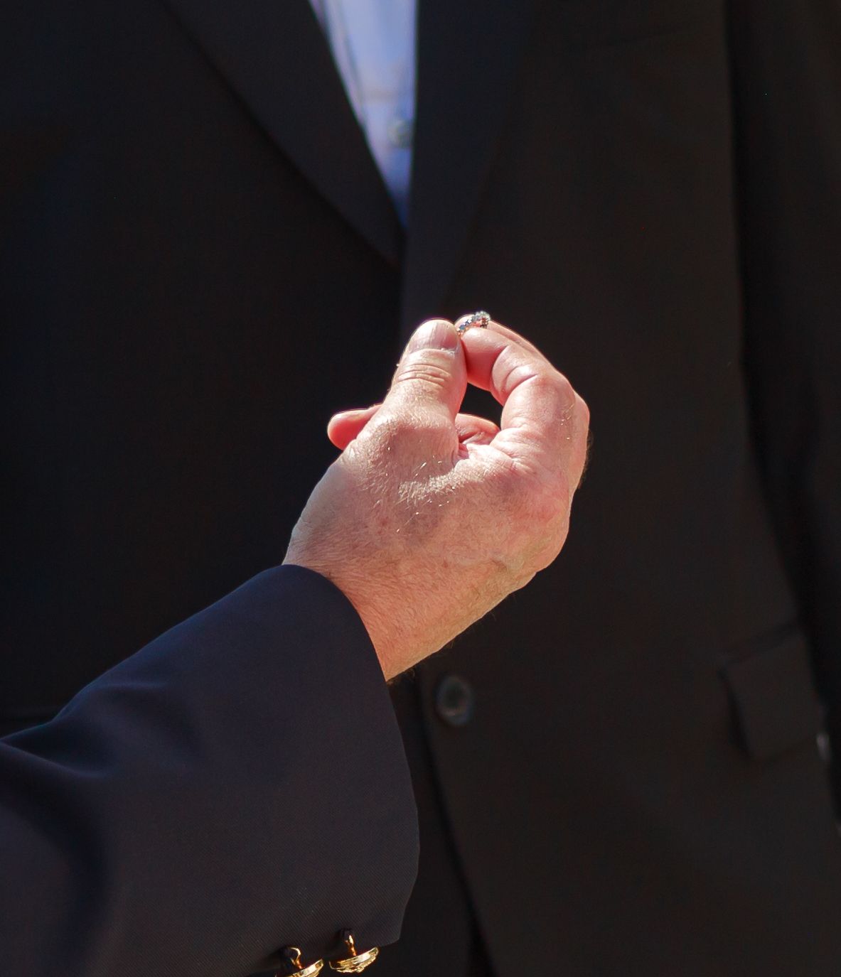 A close-up shot of raised fists against a dark background.