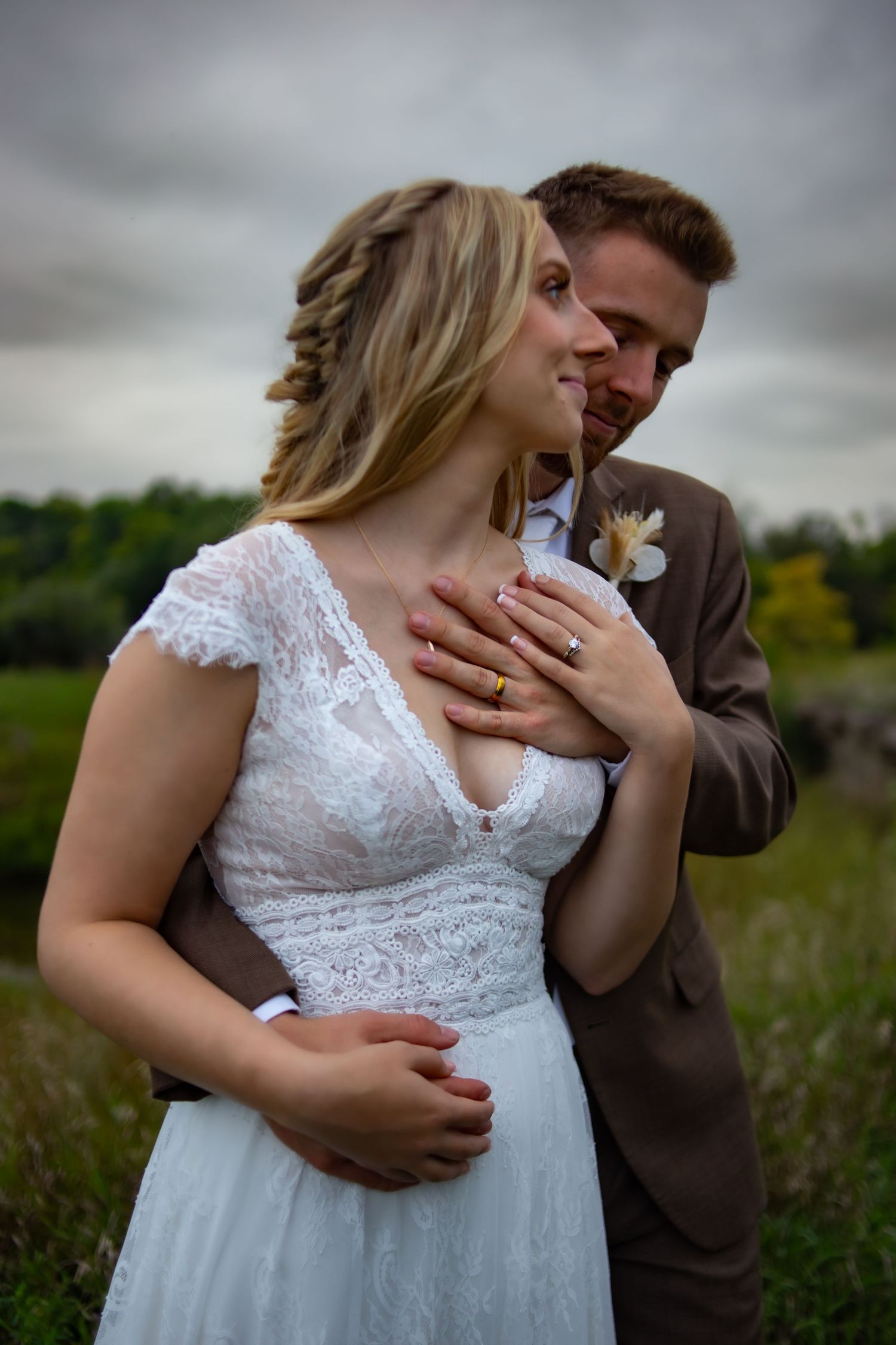 Intimate wedding portraits taken in a rustic field setting.