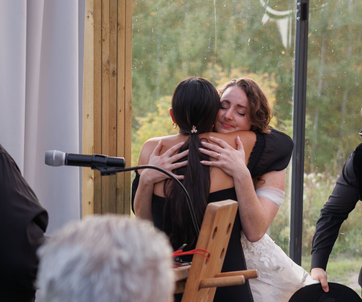 An intimate wedding moment captured indoors with wooden decor.