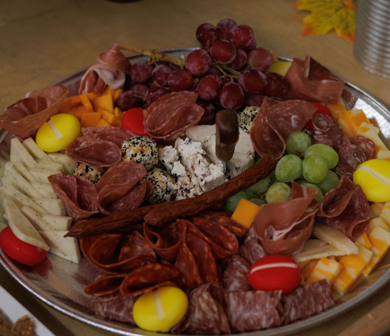 Charcuterie board with meats, cheeses, and fresh fruits arranged for a wedding reception.
