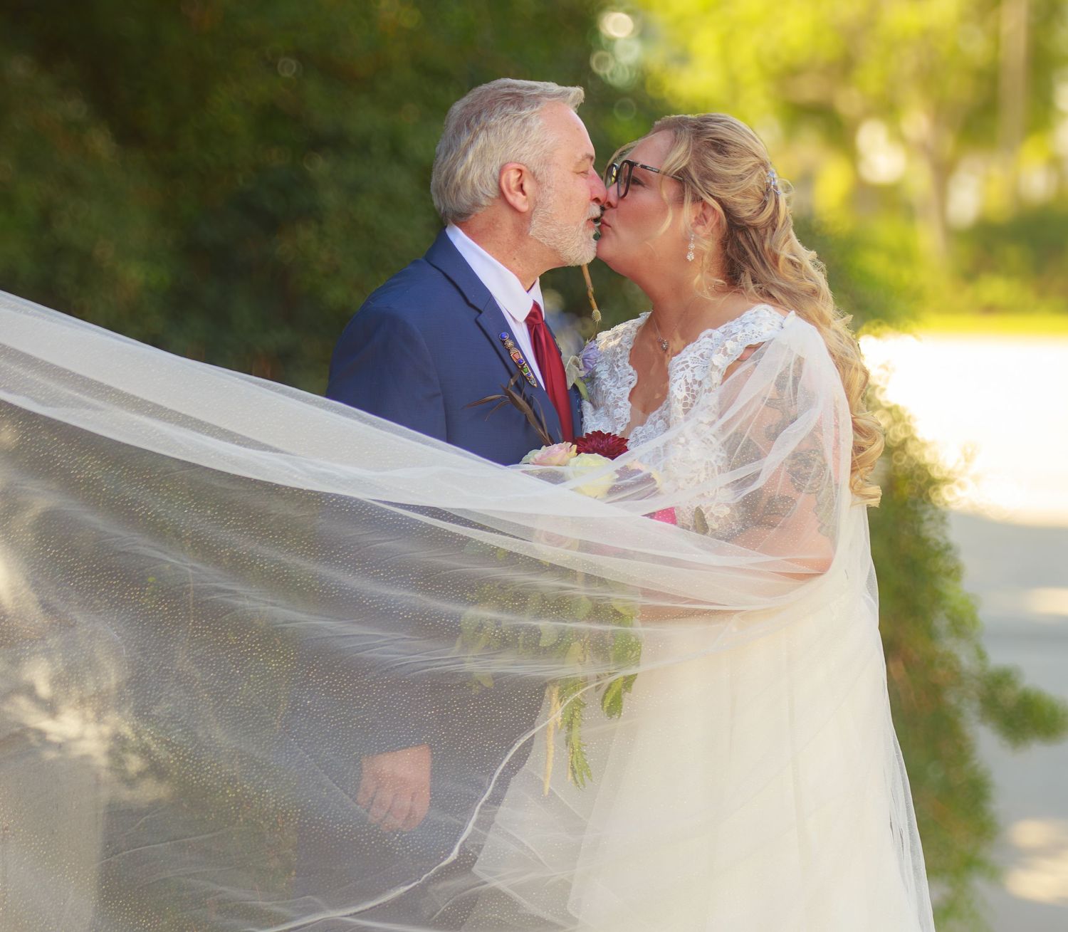 Series of romantic wedding kisses with flowing veil in natural outdoor lighting.