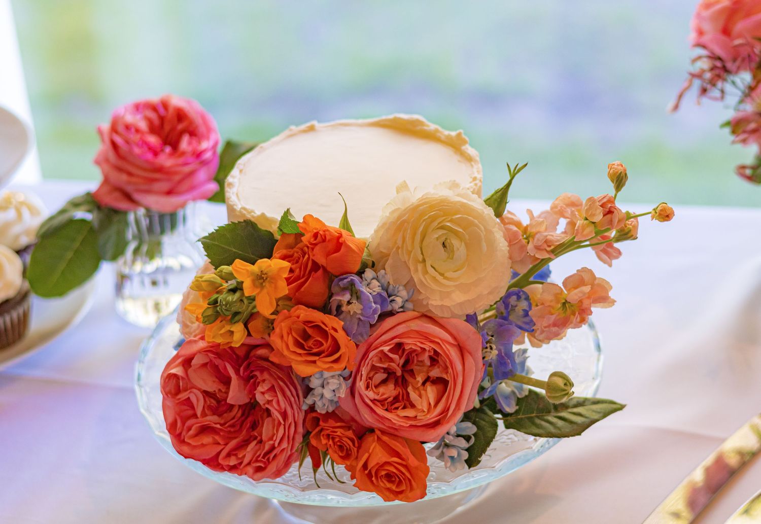 Delicate coral and pink roses arranged on light blue background.