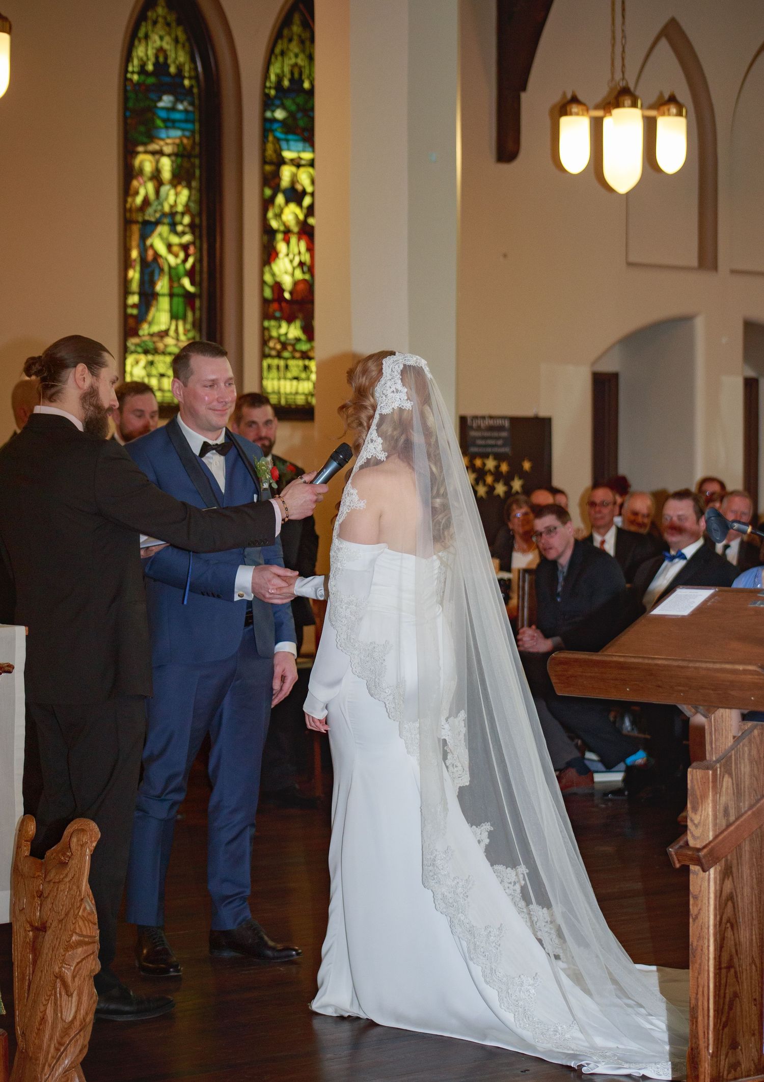 Traditional church wedding ceremony with white-gowned bride proceeding down the aisle.