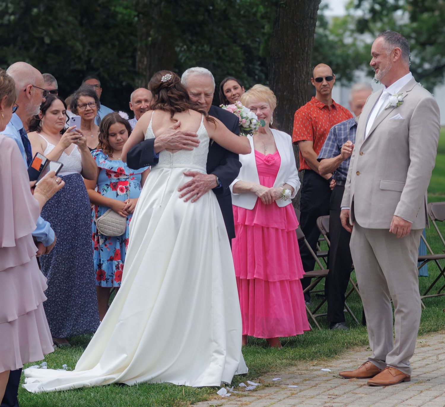 Wedding ceremony guests gather outdoors to celebrate the special moment.