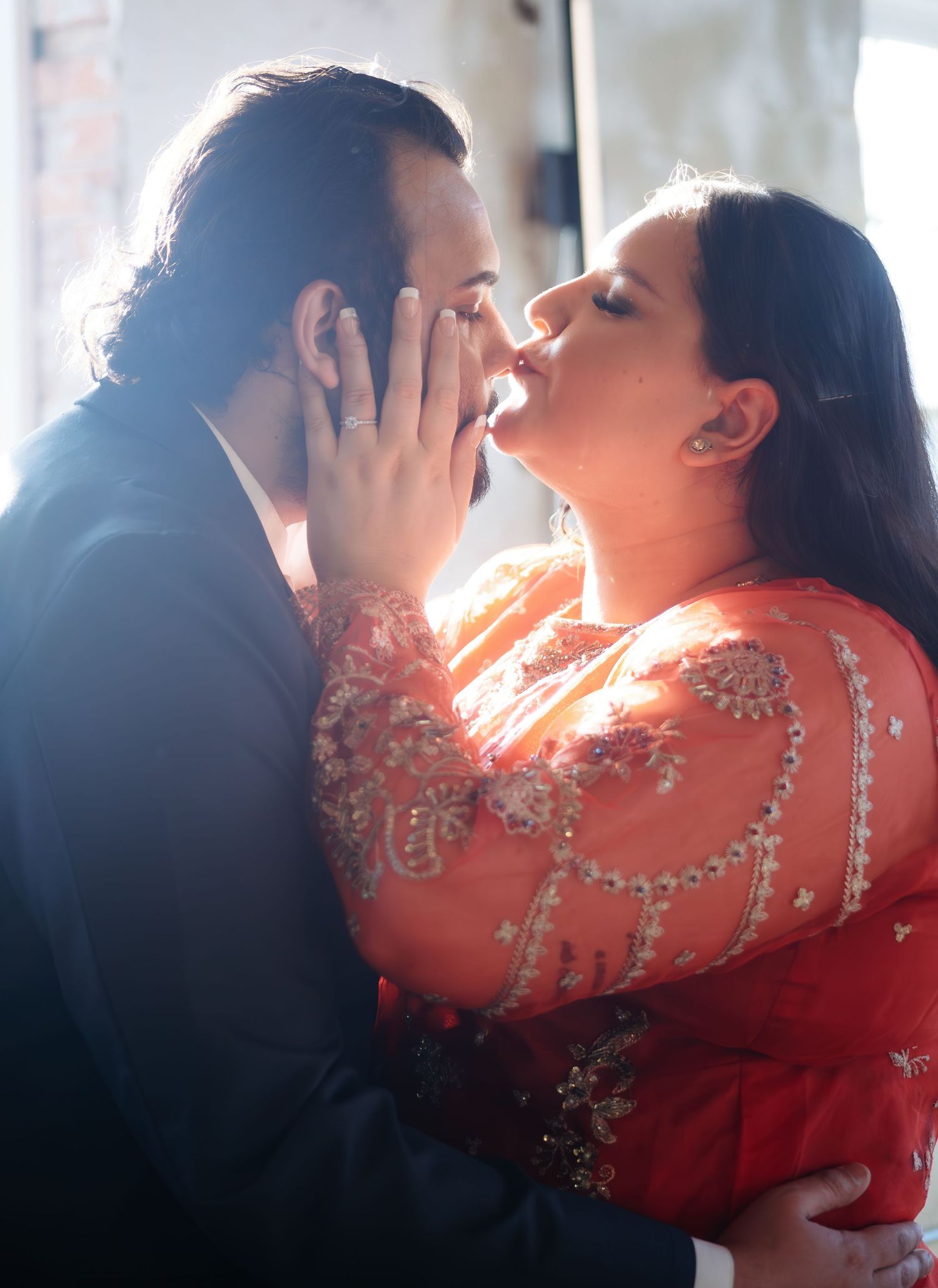 Intimate dance moment captured in backlit window sequence with formal attire.
