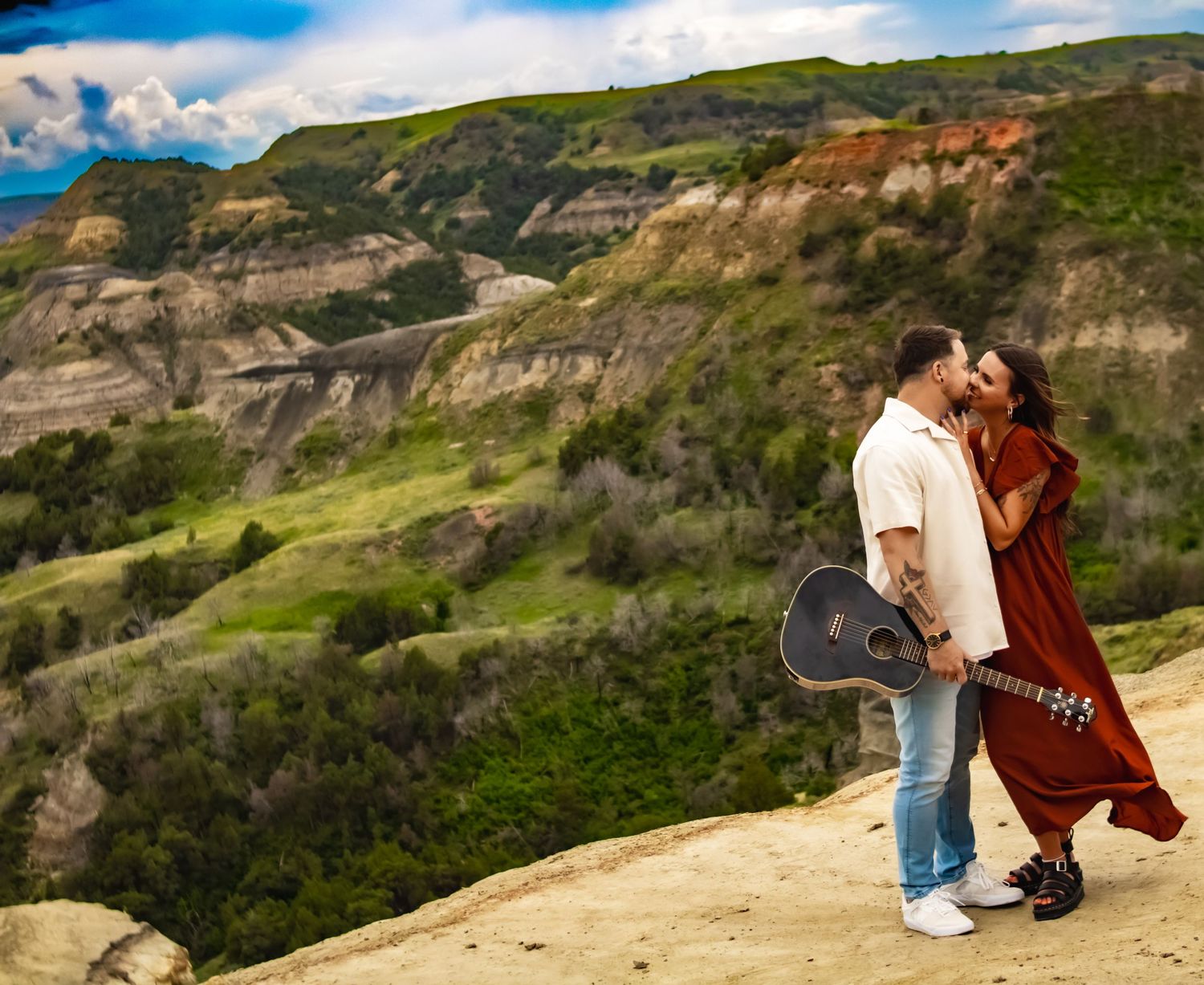 Scenic mountain landscape with couple sharing intimate moment on rocky terrain.