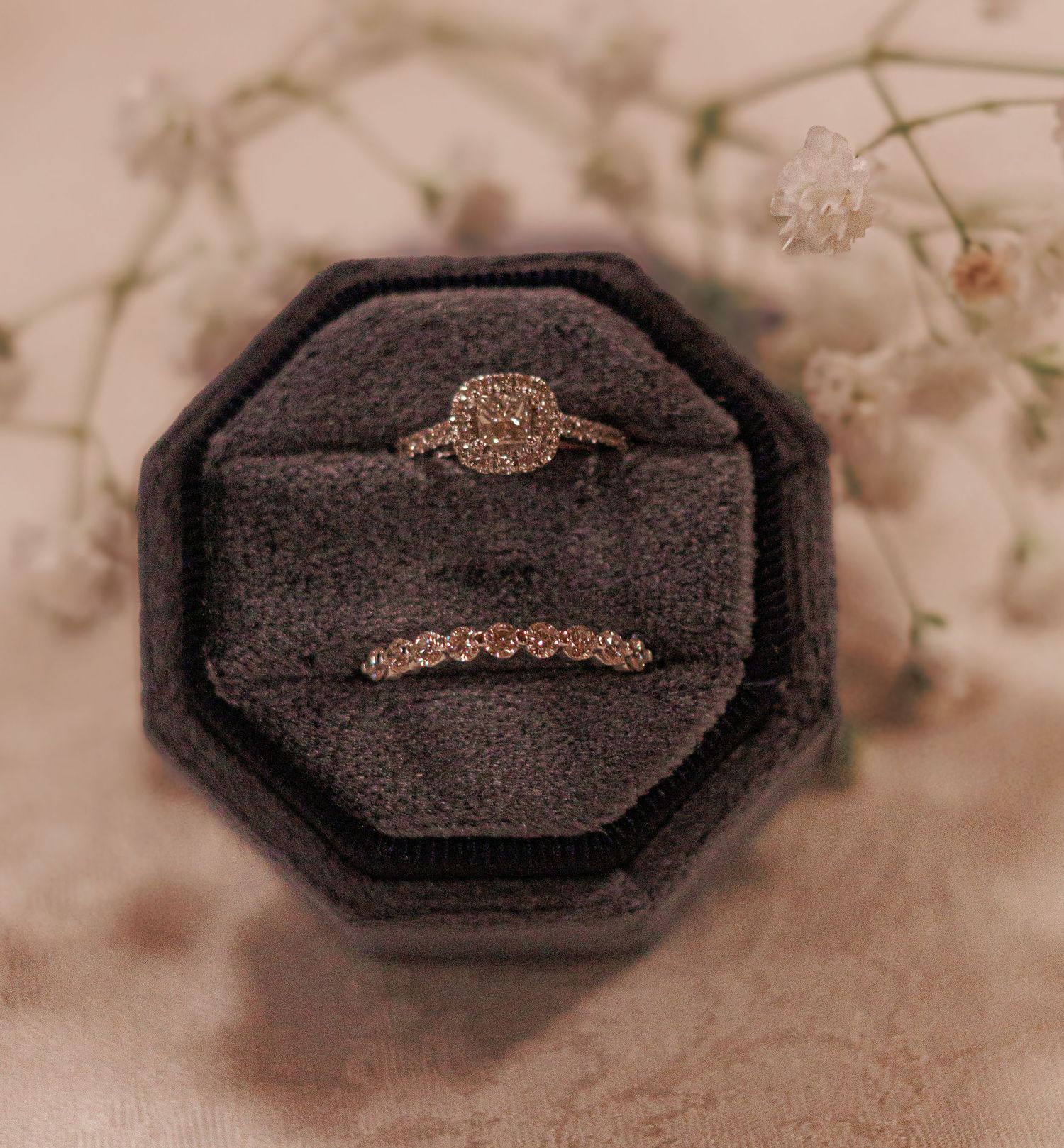 Close-up sequence of a rose gold engagement ring in an antique octagonal box with delicate floral details.