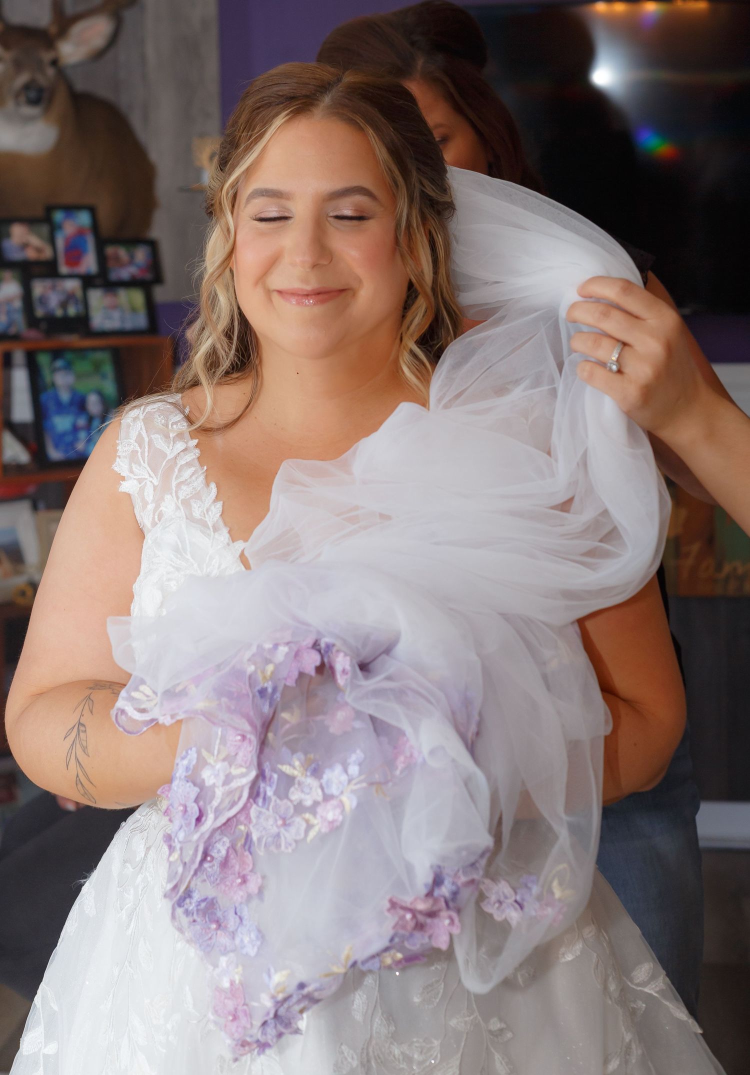 Bride twirling in a white wedding gown with purple floral accents.
