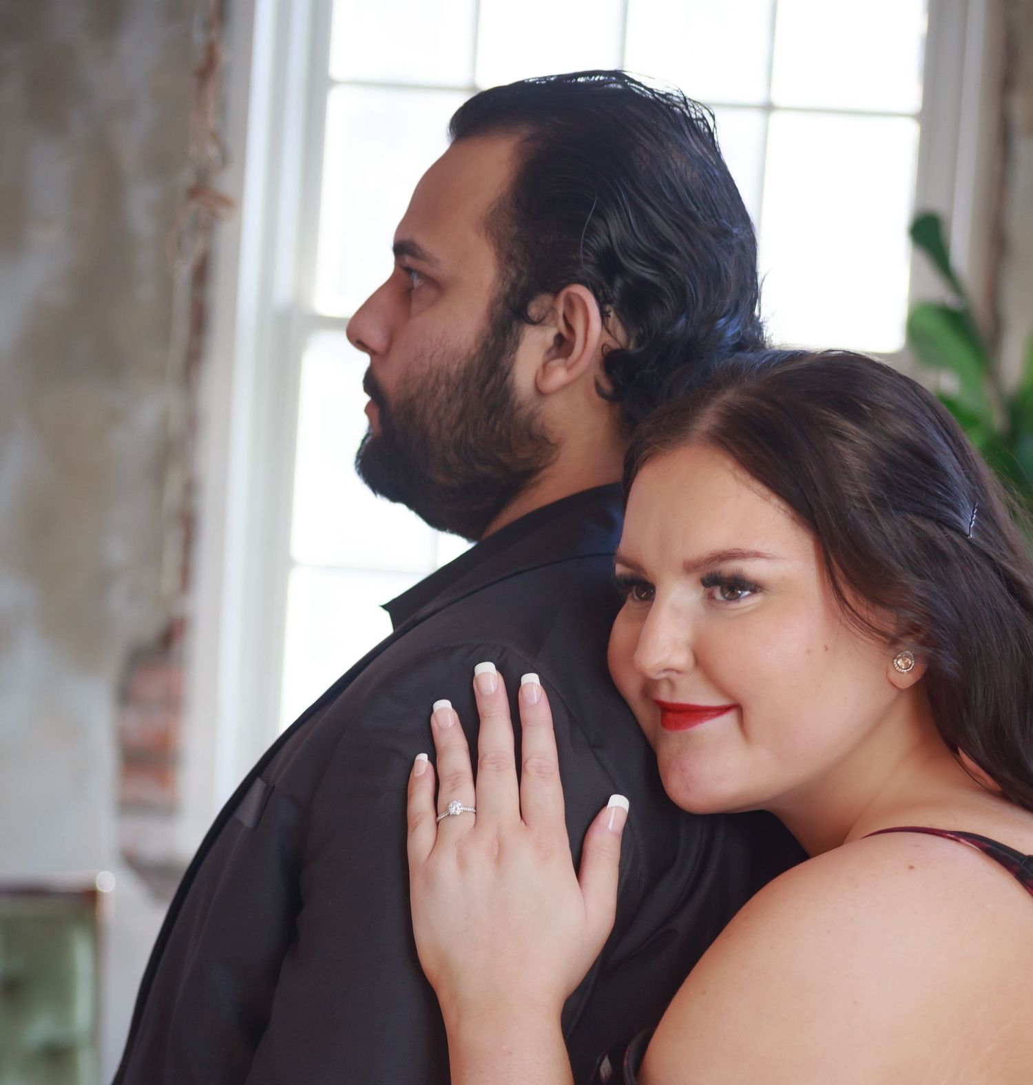 Romantic portrait sequence in a sunlit room with exposed brick walls and greenery.