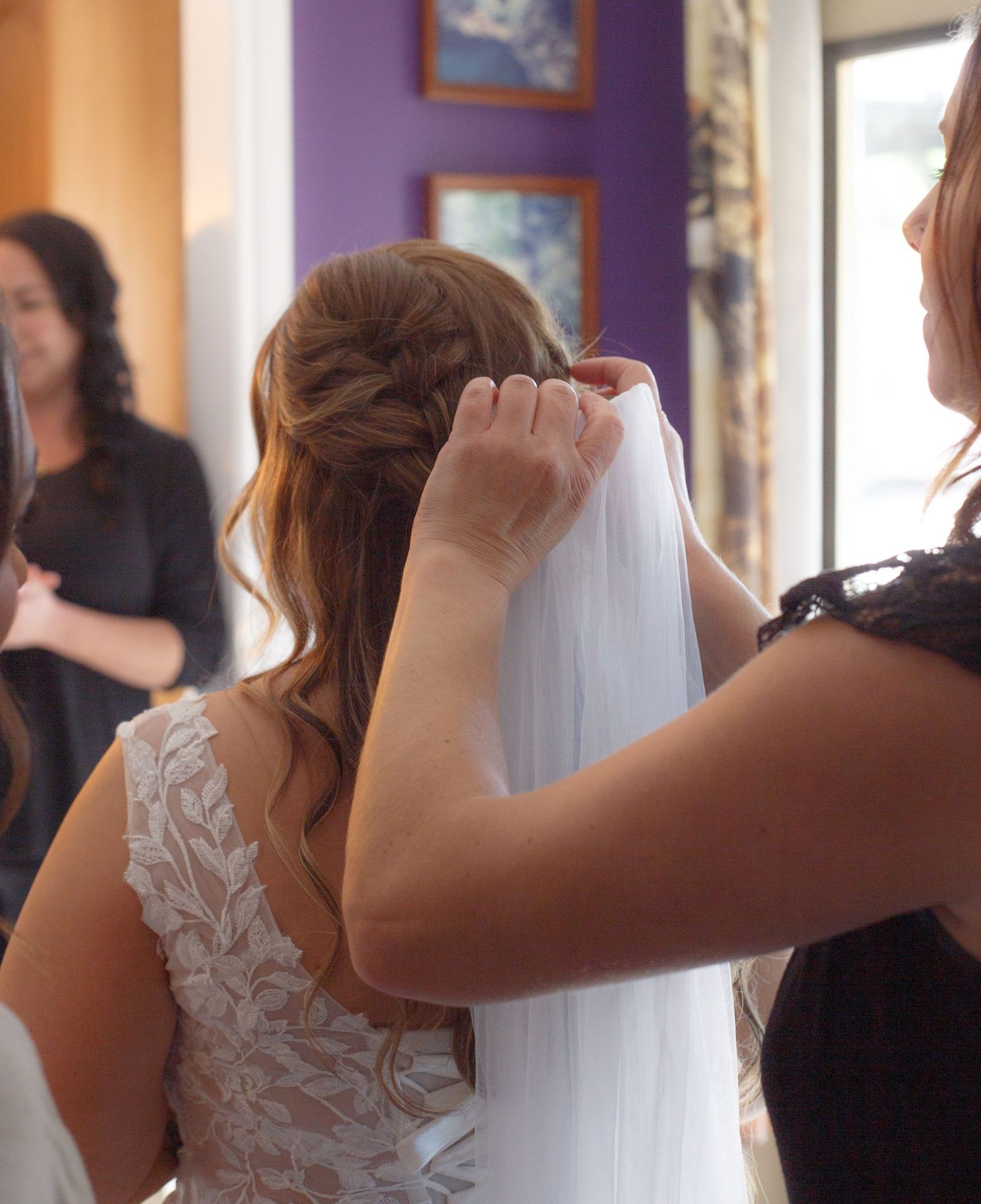 Close-up of wedding dress preparations with lace details and veil.