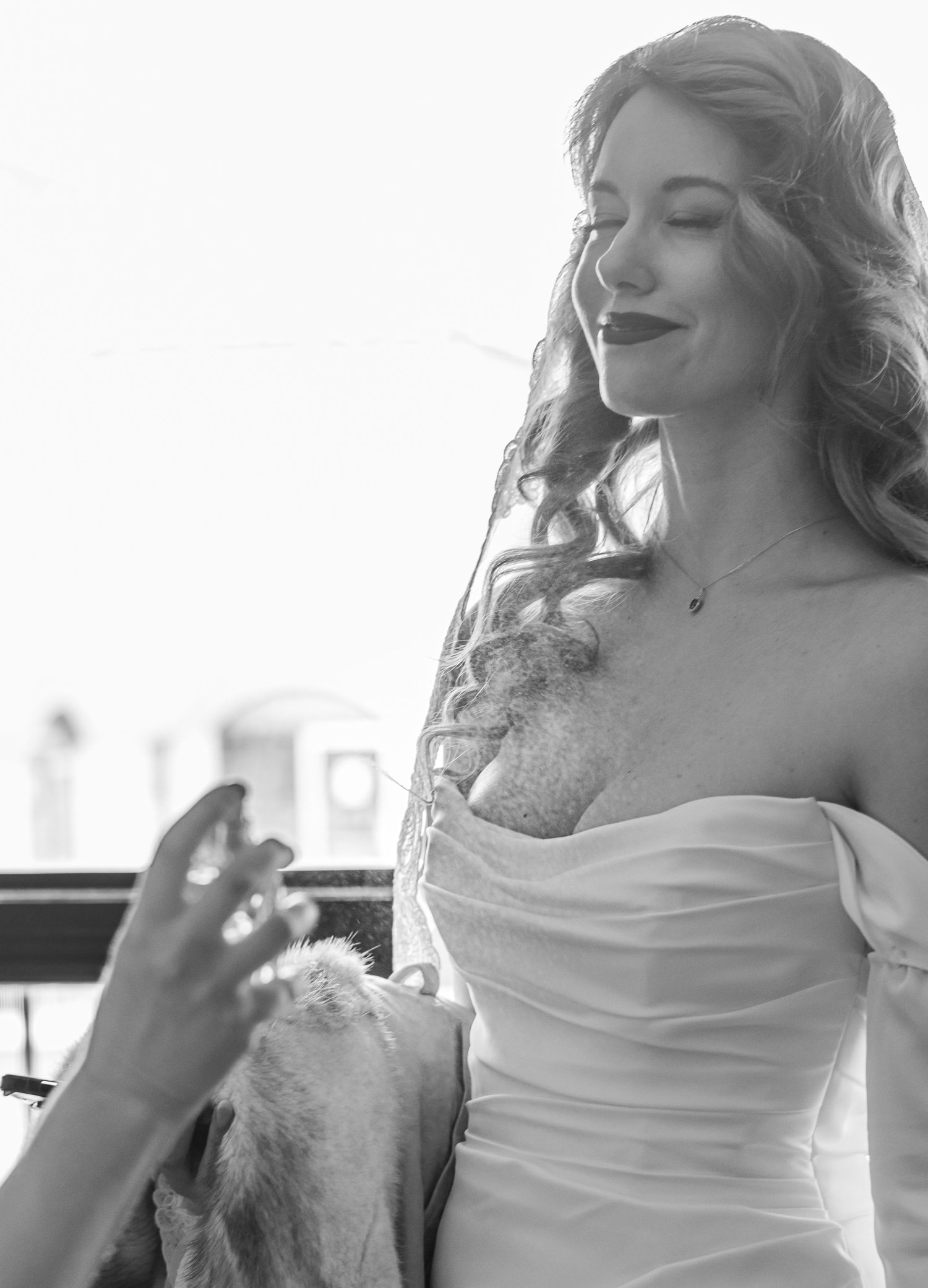 Black and white candid shot of bride in strapless gown.
