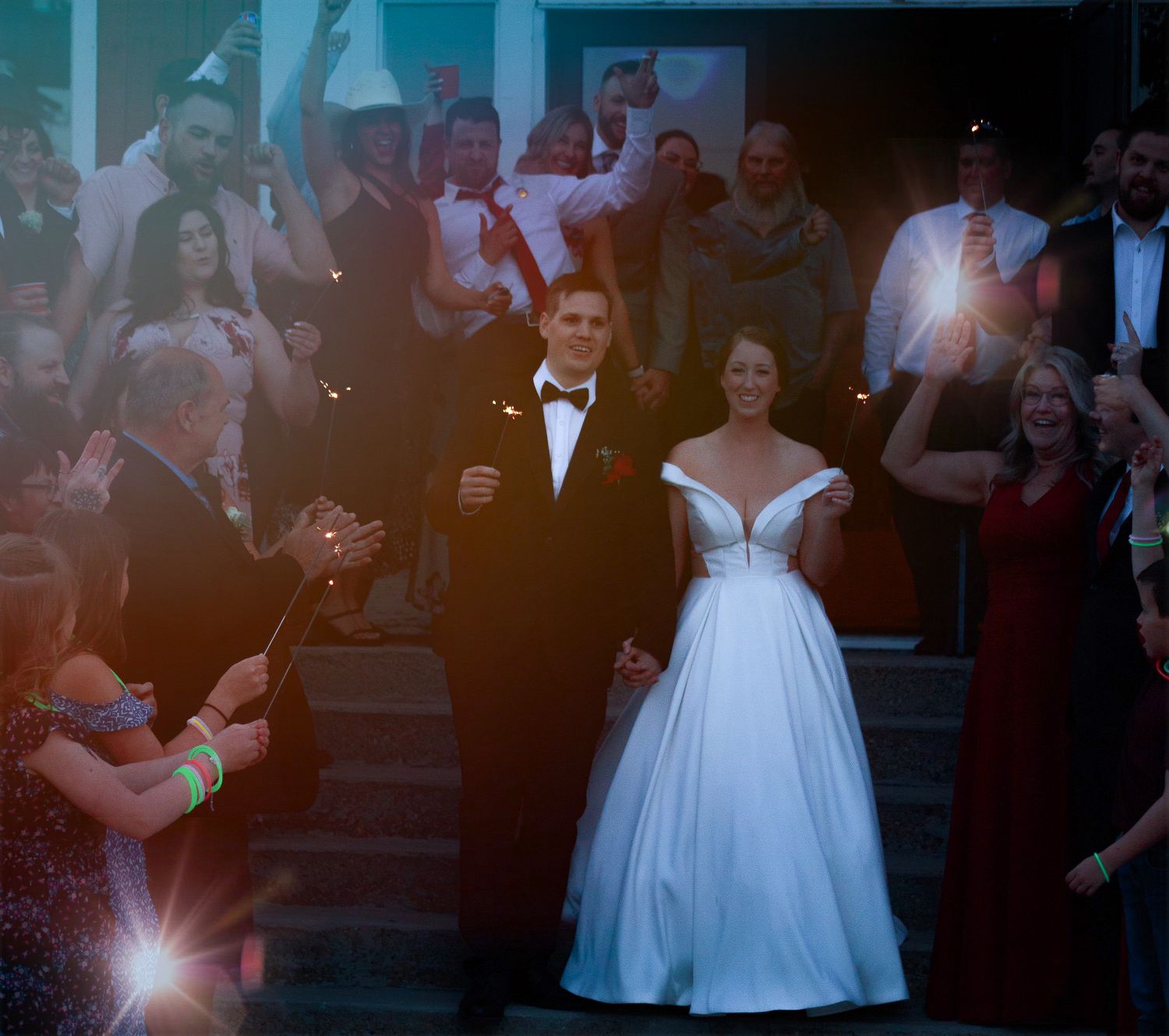 Wedding reception dance captured in dramatic lighting.