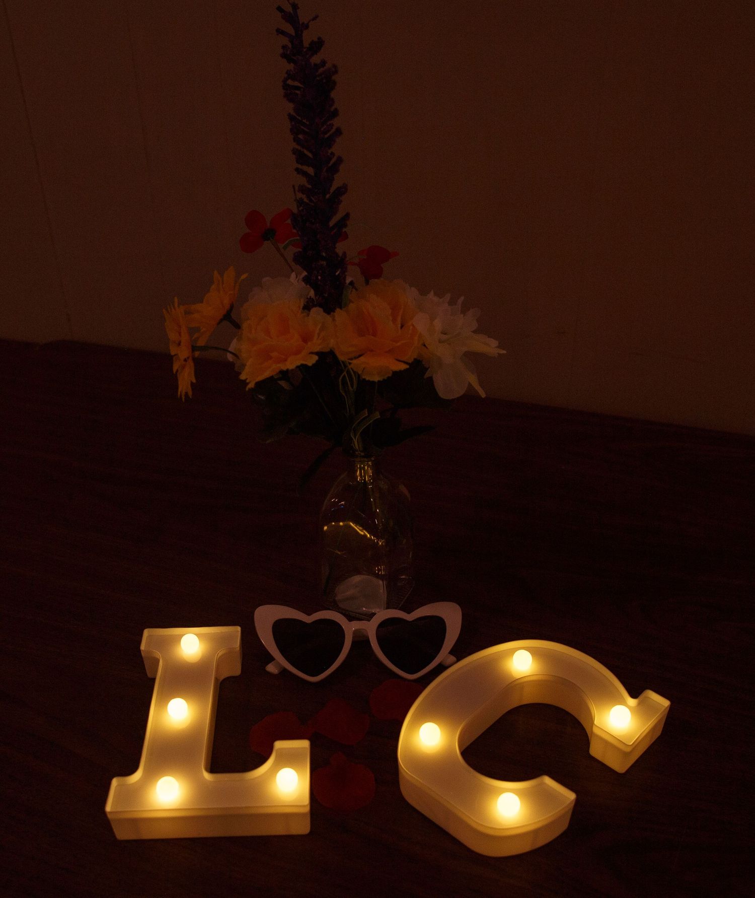 Illuminated LOVE letters create romantic ambiance against dark background.