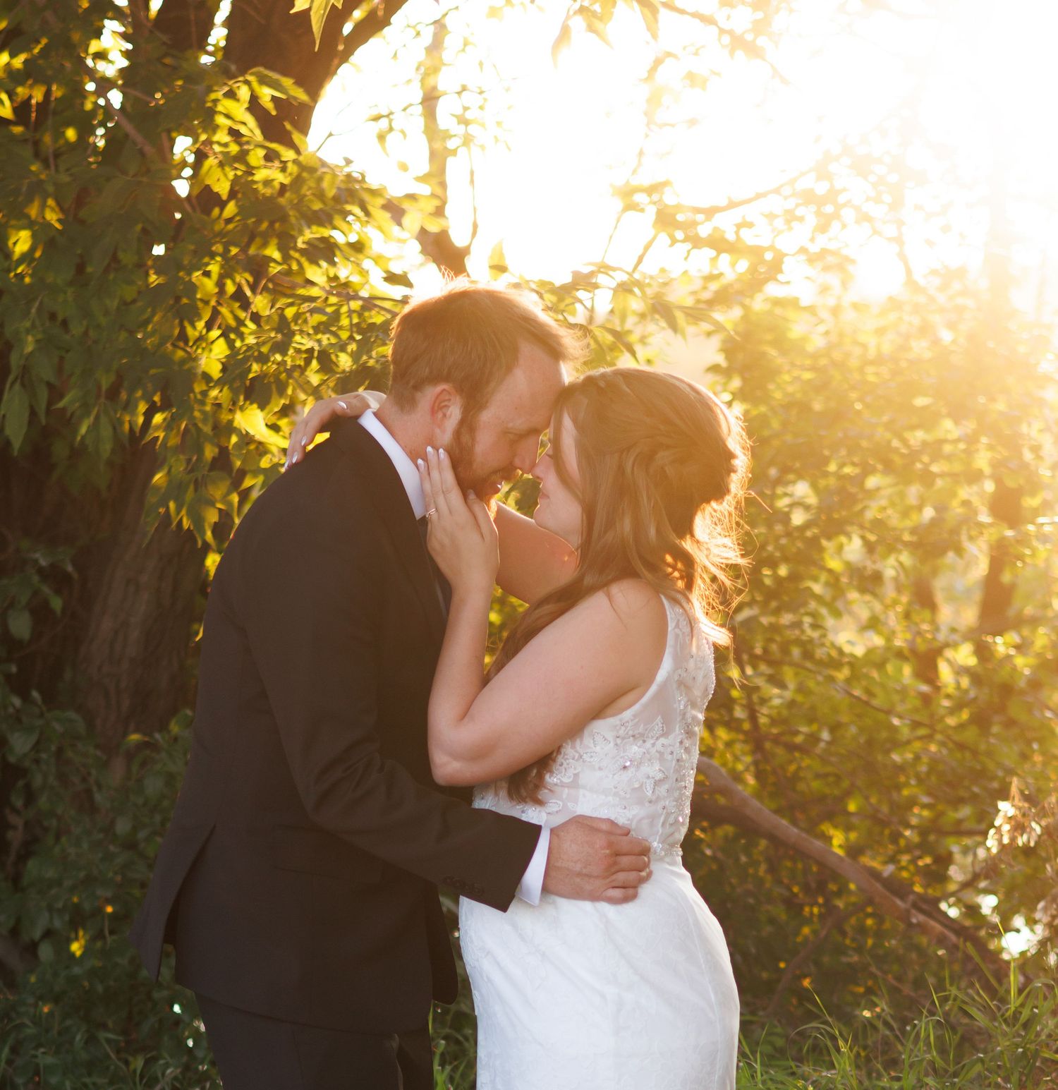 Romantic sunset wedding photos capture intimate moments between newlyweds.