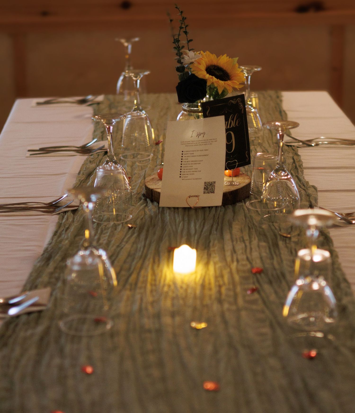 Elegant table setting with wine glasses and candlelight for a wedding reception.