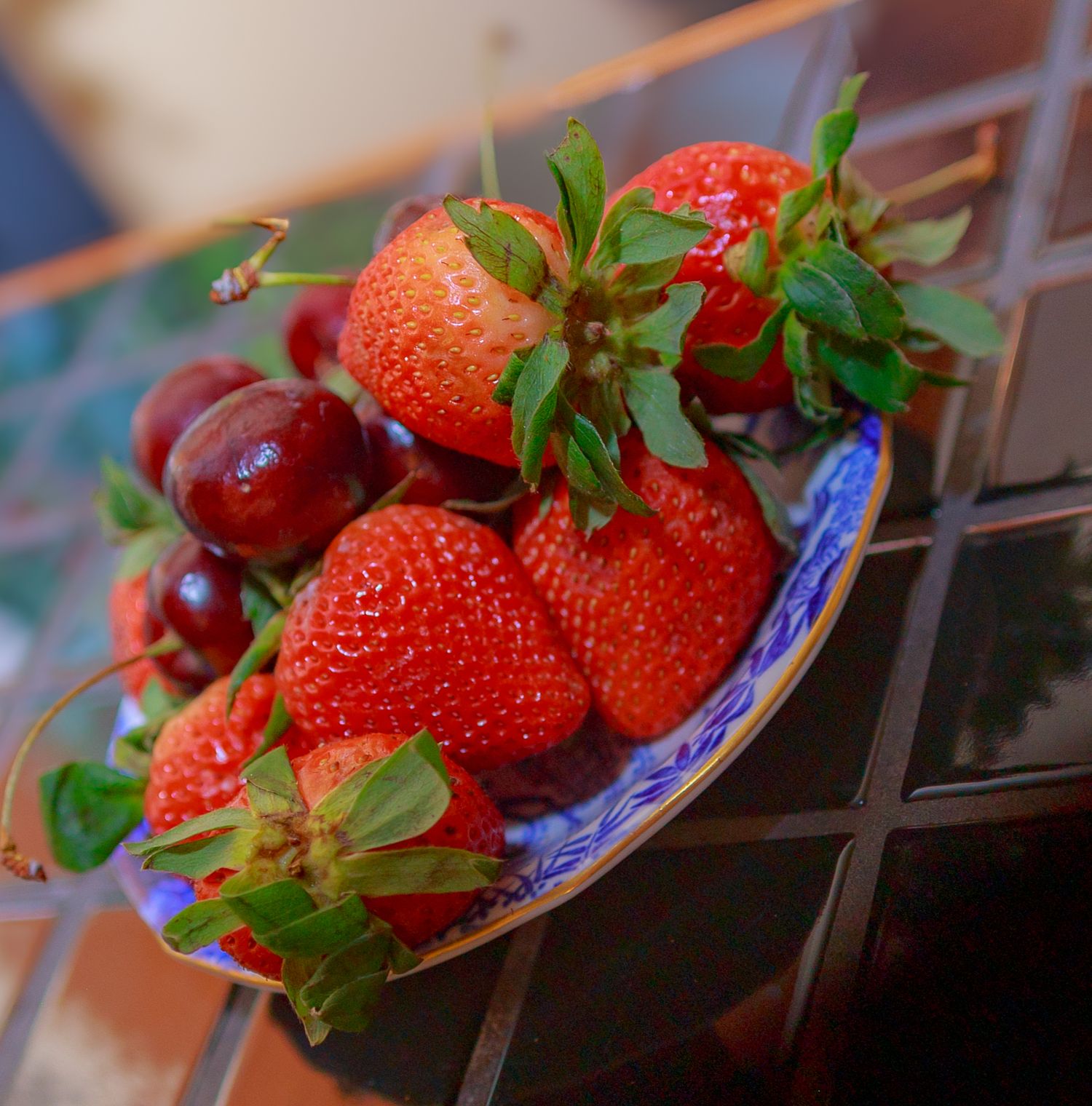 Fresh red strawberries arranged on blue plates for an elegant wedding dessert display.
