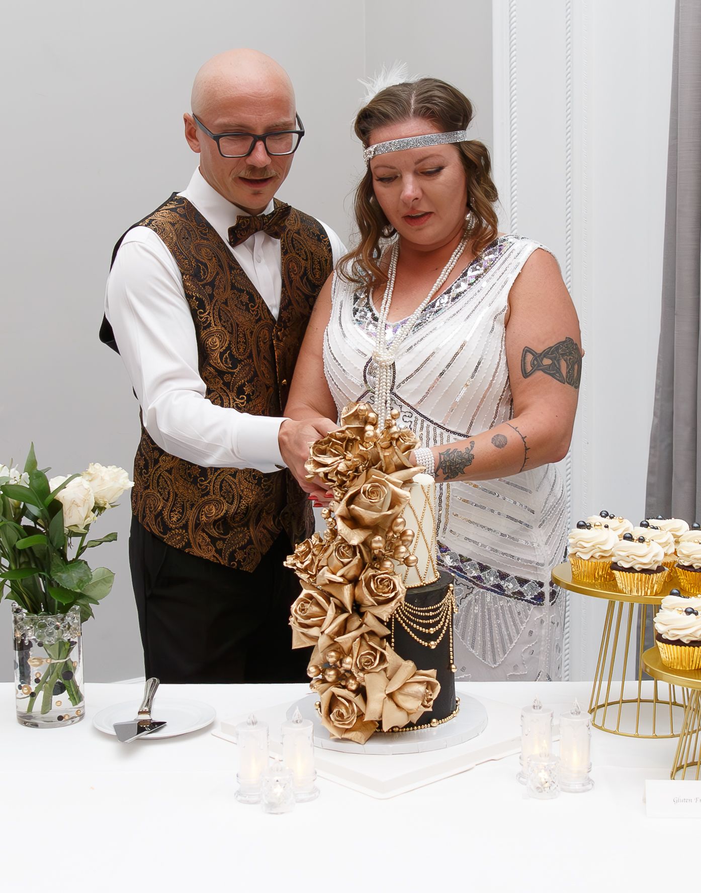 Couple sharing an intimate moment at a wedding reception with gold decorative details.