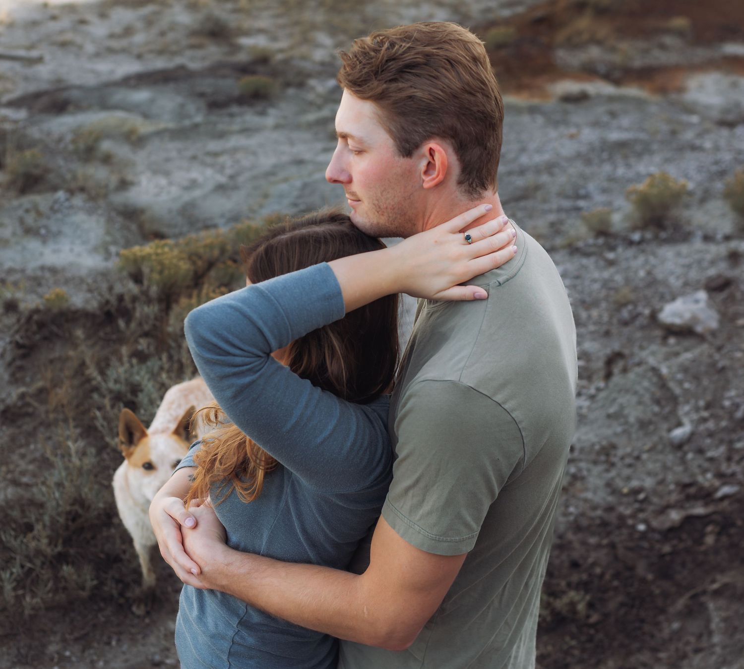 Intimate outdoor photoshoot sequence with a couple and their dog on rocky terrain.