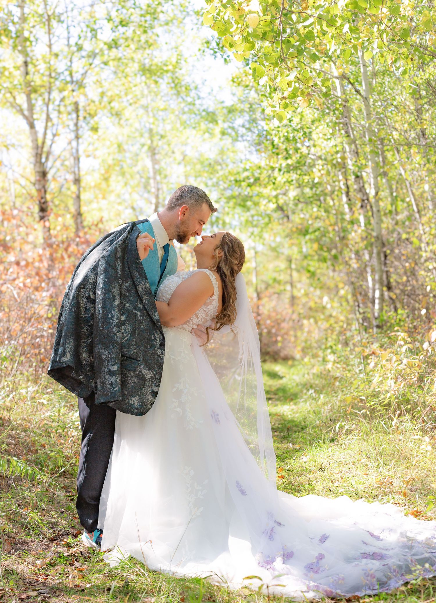 Romantic wedding photos taken in a wooded setting during golden hour.