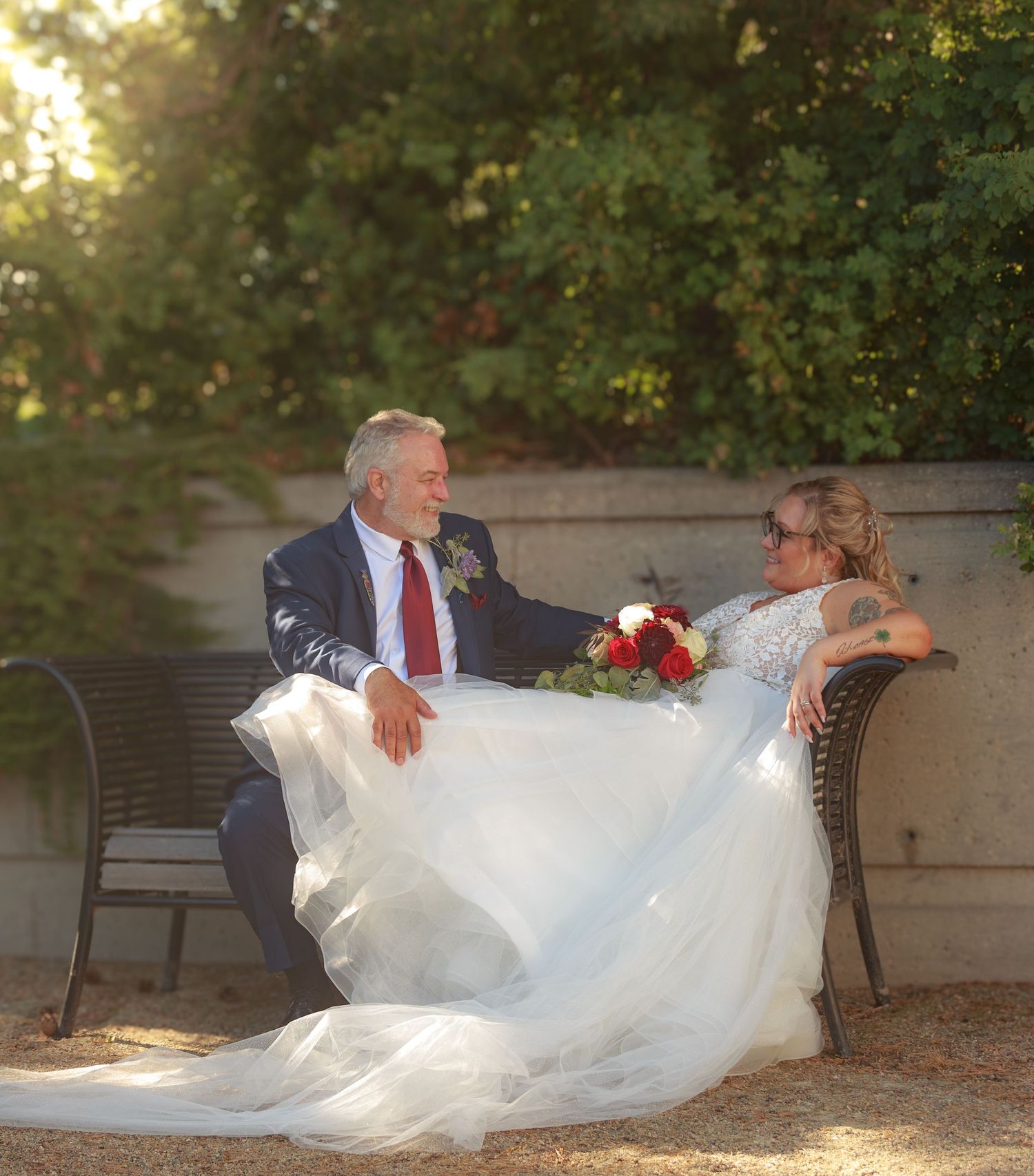 Romantic wedding portrait sequence on a bench showing playful moments between newlyweds.