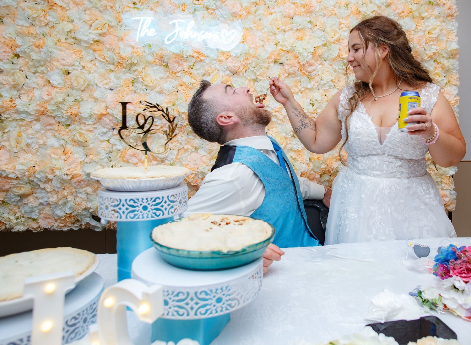 Wedding cake smash moment captured during reception celebration.