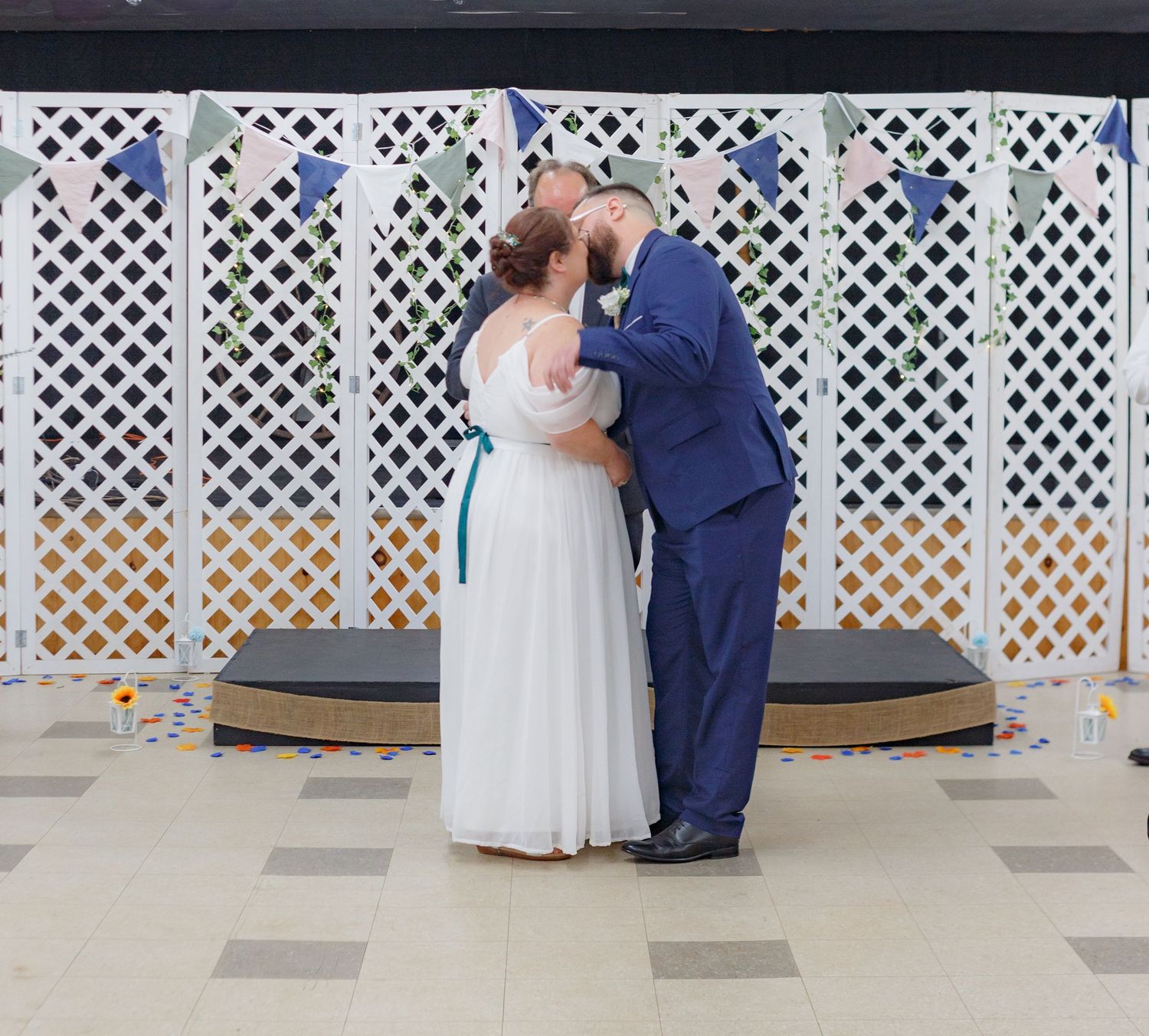 Wedding ceremony moments captured in front of decorative white lattice panels.