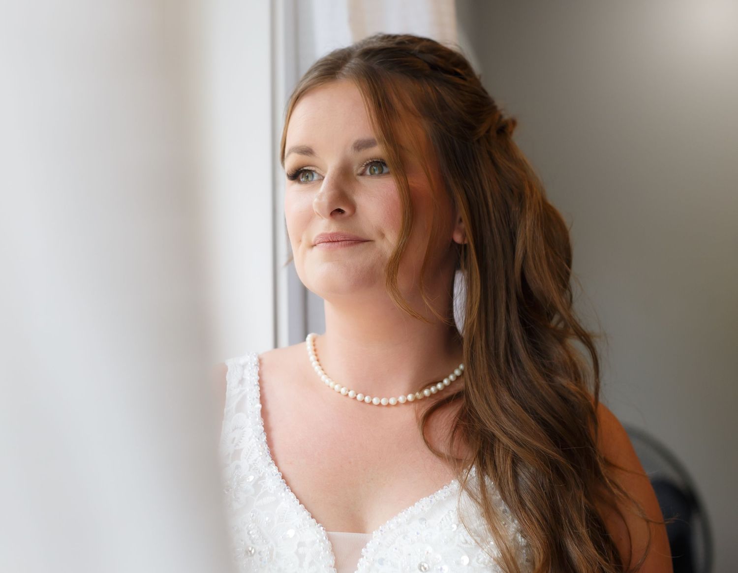 Close-up portrait shots showing elegant bridal details including pearl necklace and lace dress.
