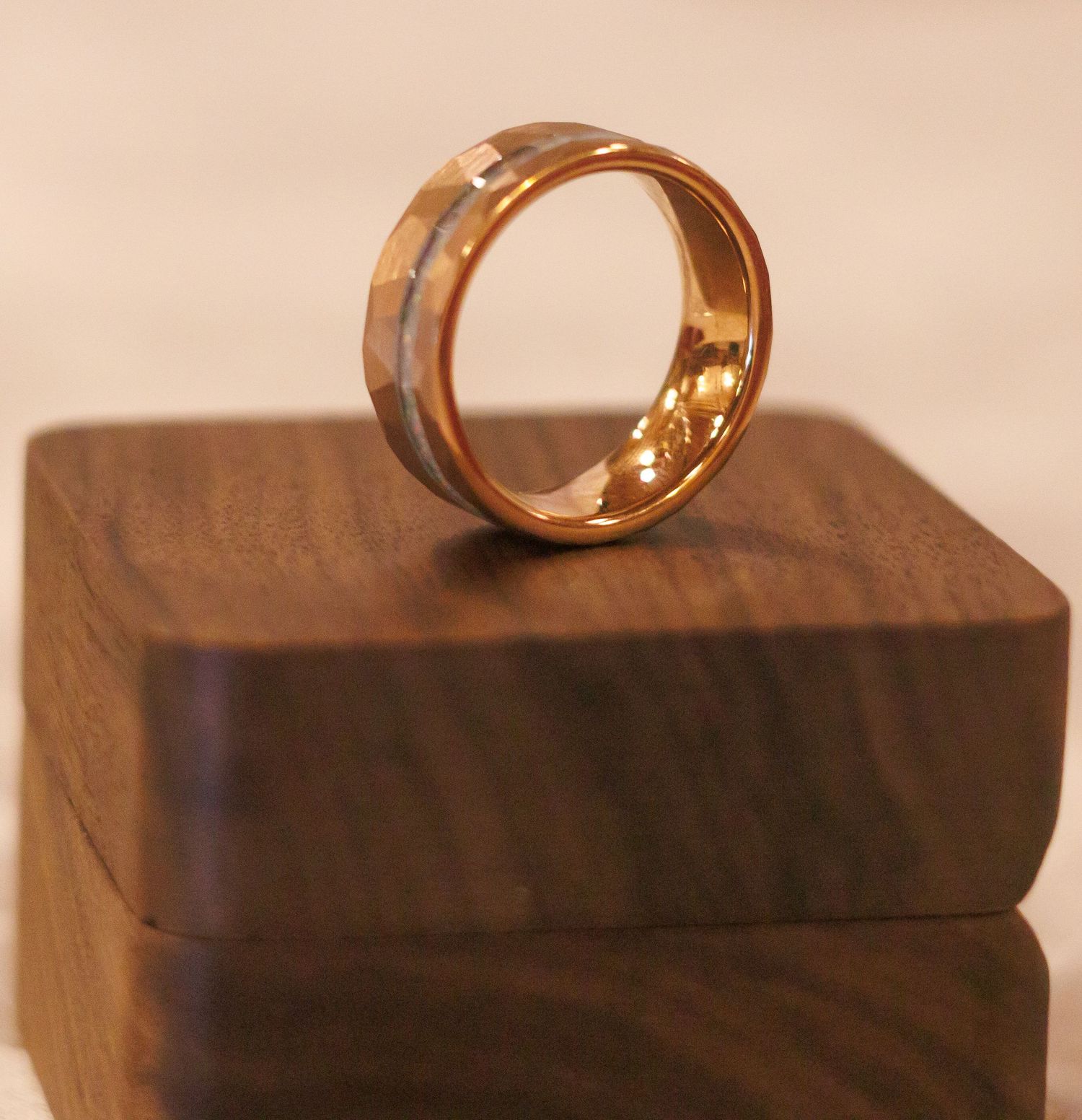 Gold wedding rings displayed on a wooden surface.
