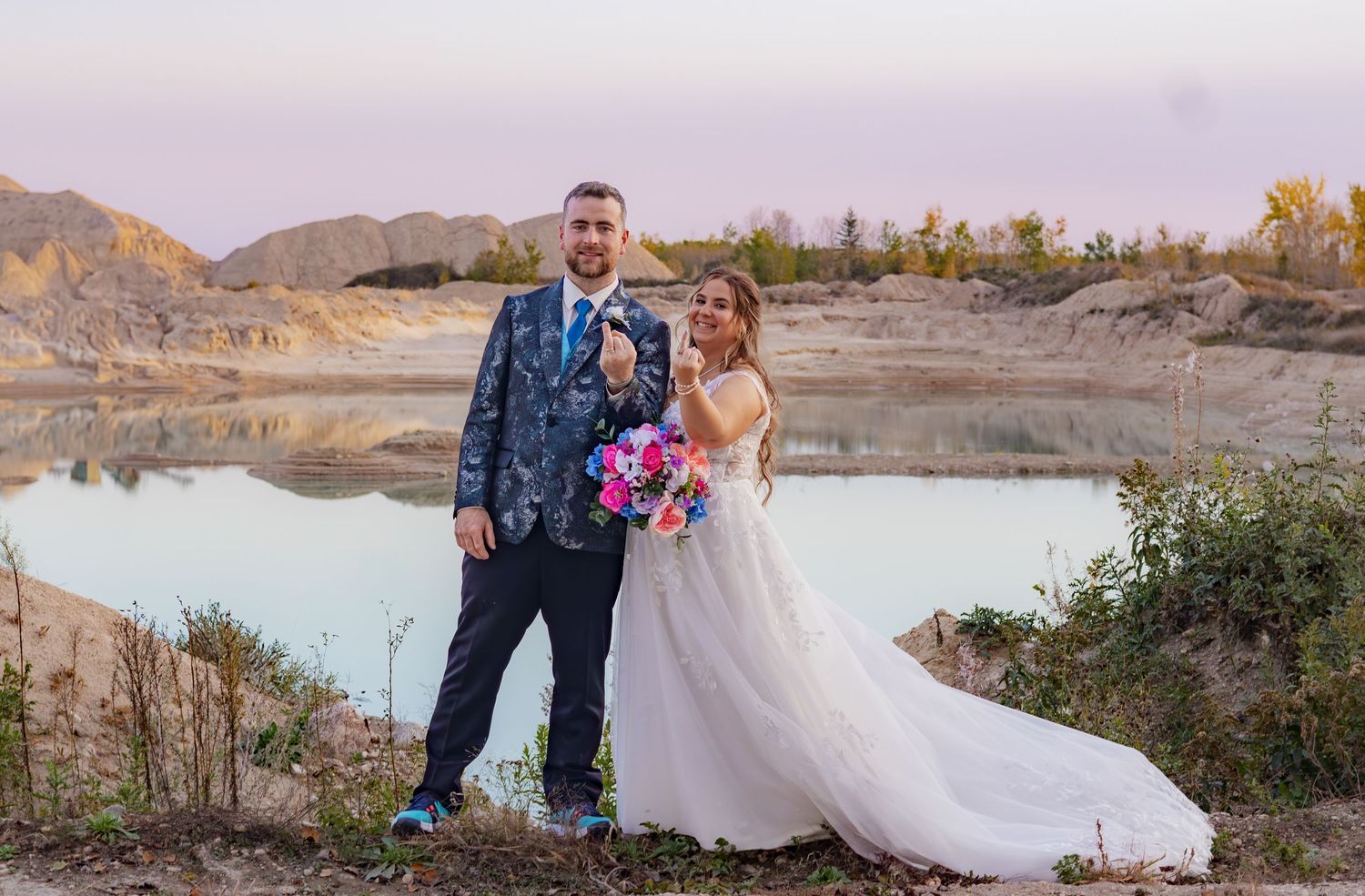 Scenic outdoor wedding photos captured against a desert landscape with a lake in the background.