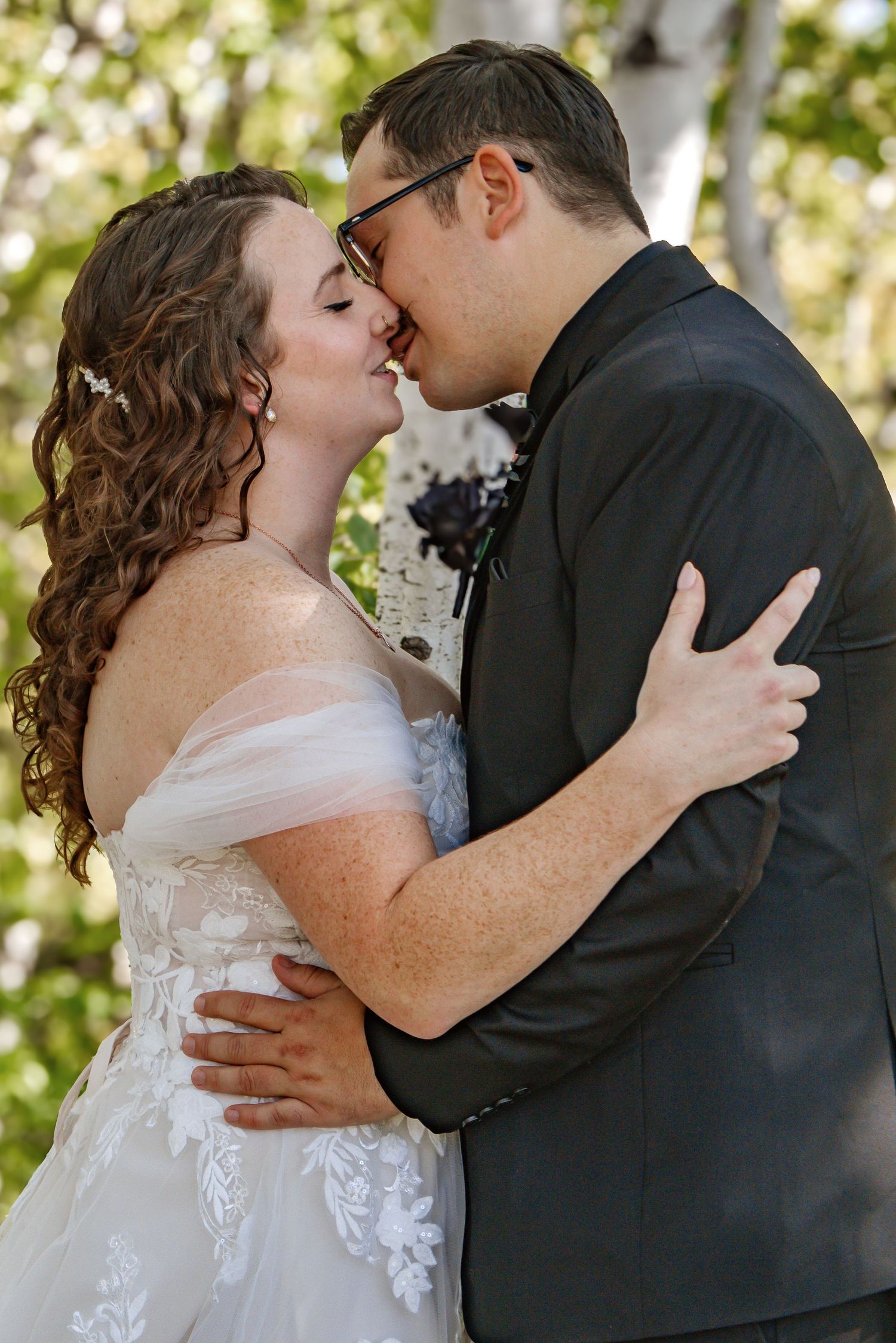 Intimate wedding portrait moment captured in natural outdoor lighting.