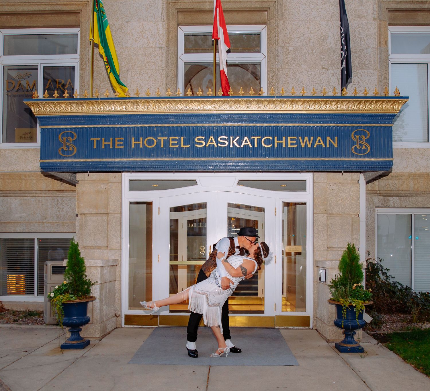 Exterior view of The Hotel Saskatchewan with classic architecture and entrance signage.