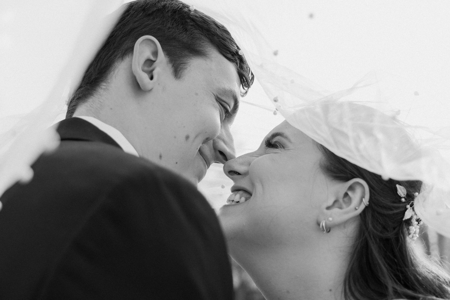 Black and white romantic wedding portrait showing couple in intimate moment.