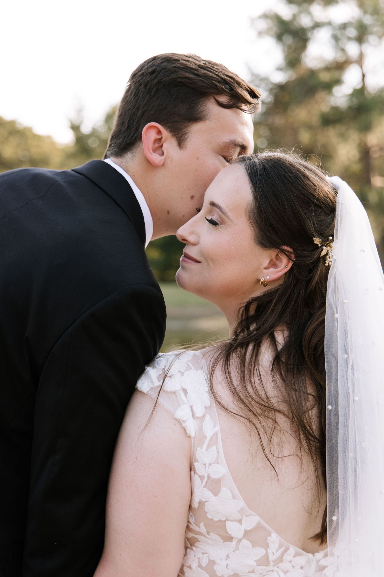 An intimate romantic moment between newlyweds captured during sunset.