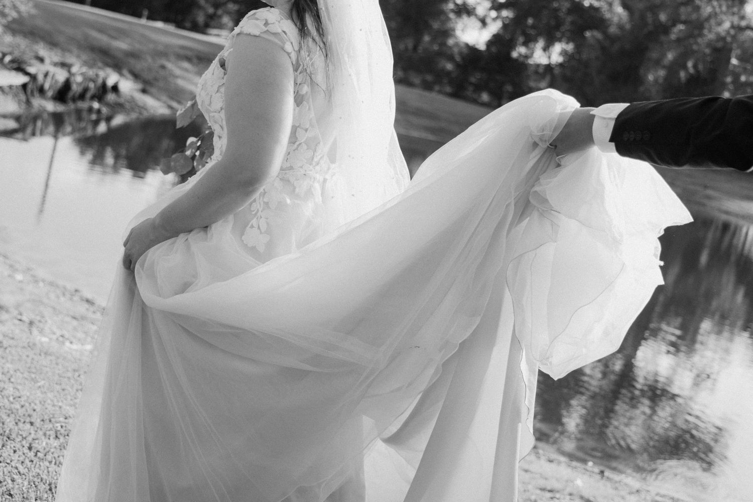 Dreamy bridal portraits in black and white showing flowing dress movement outdoors.