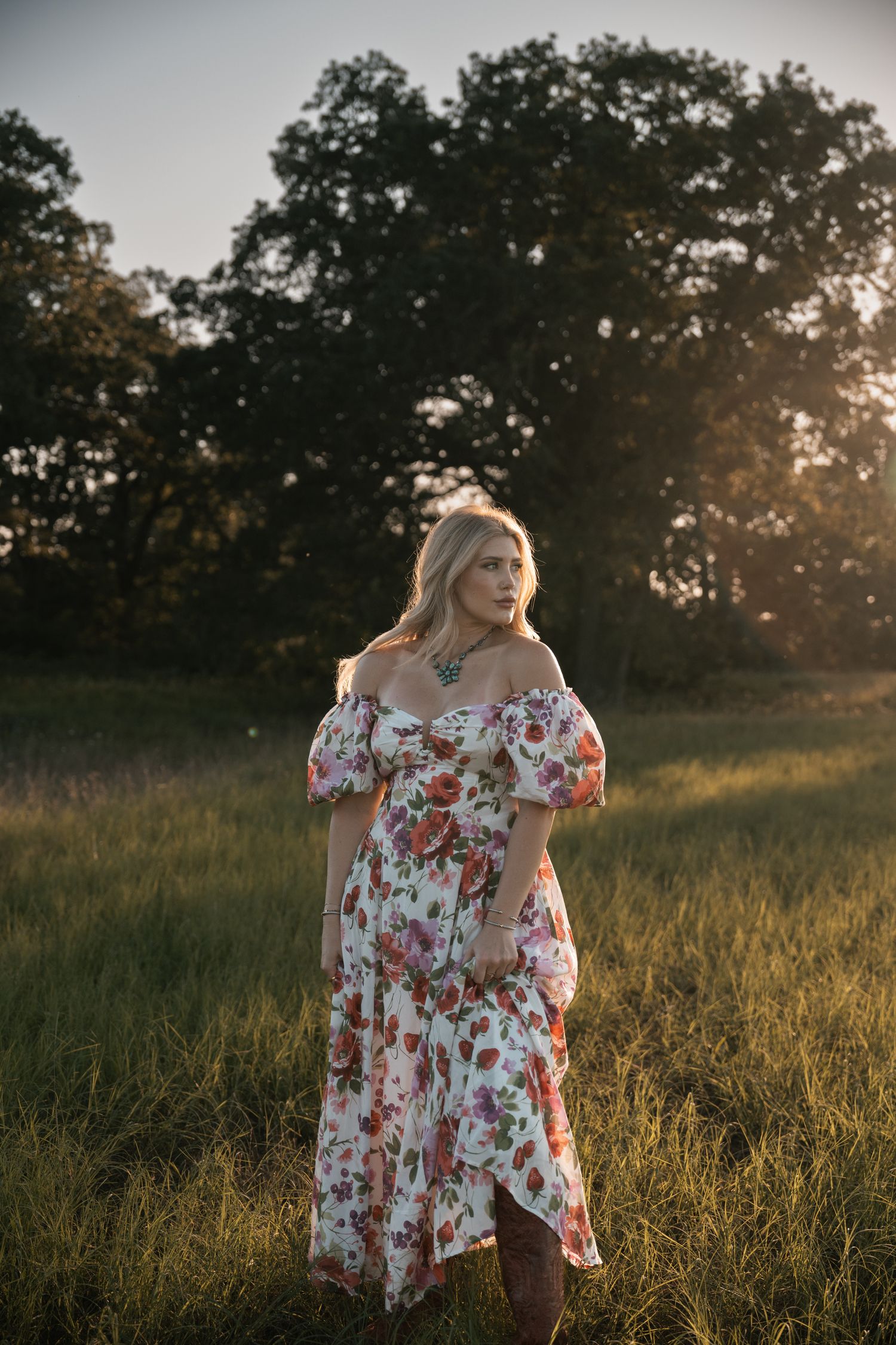 Dreamy portrait in floral off-shoulder dress during golden hour.