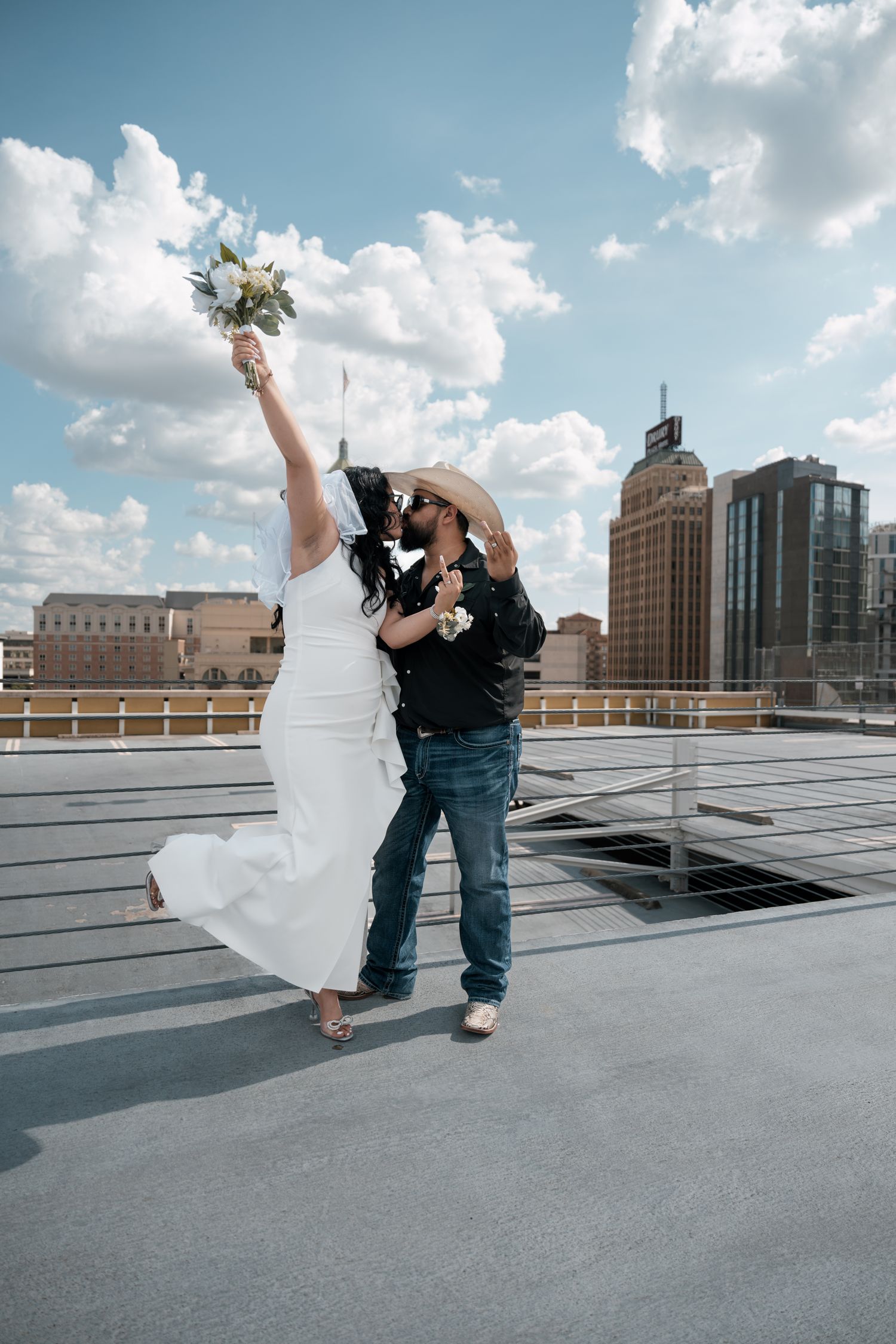 Romantic rooftop moment with cityscape backdrop.