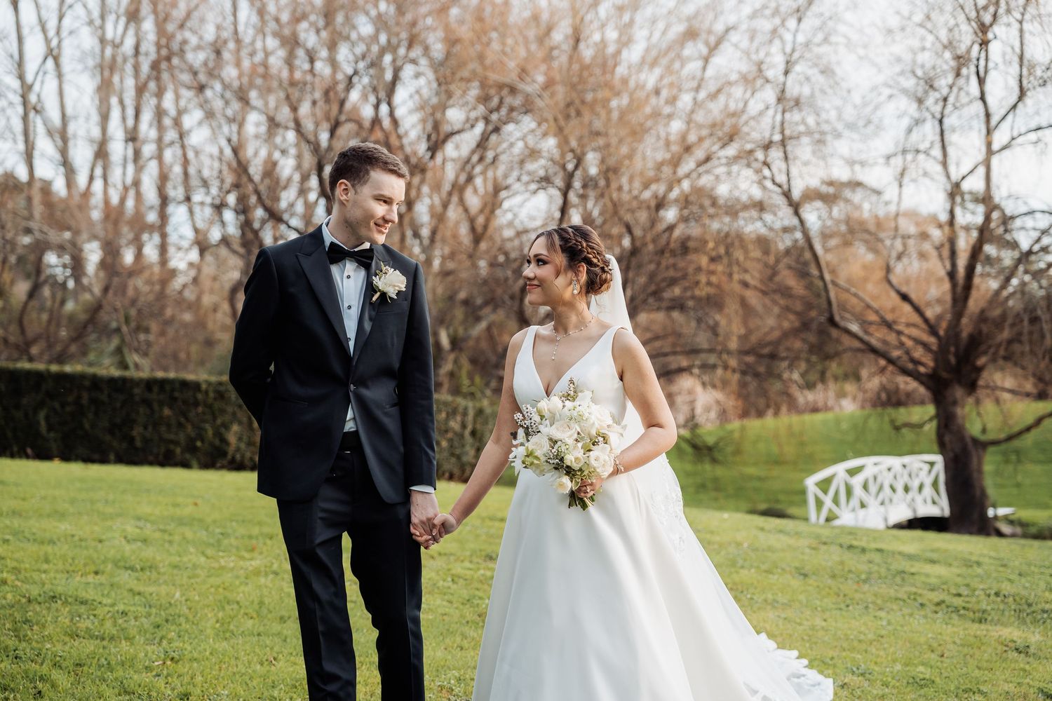 A beautiful wedding celebration on a grassy lawn with bare trees in the background.