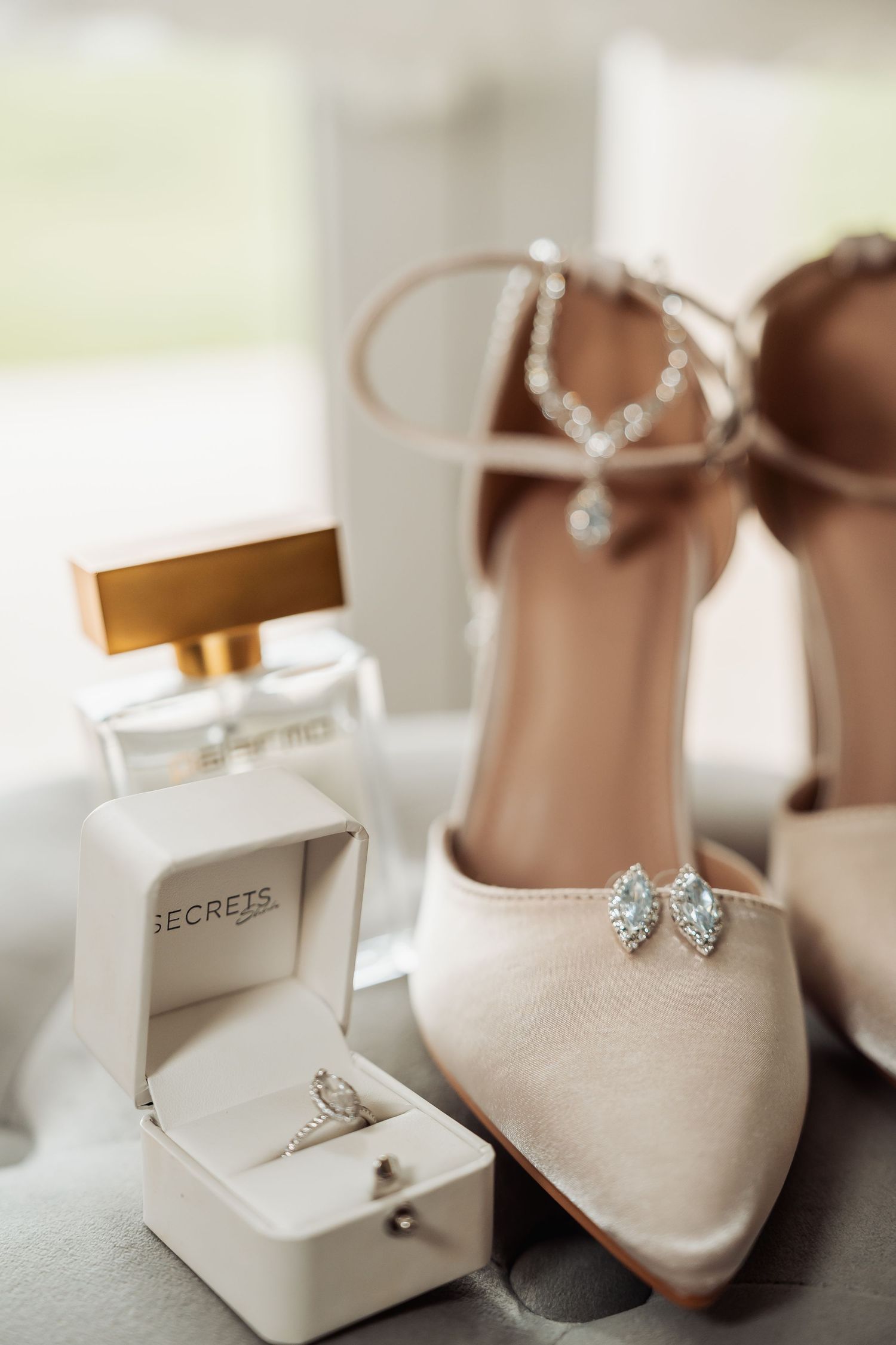 Elegant bridal accessories including shoes and jewelry displayed in white boxes.