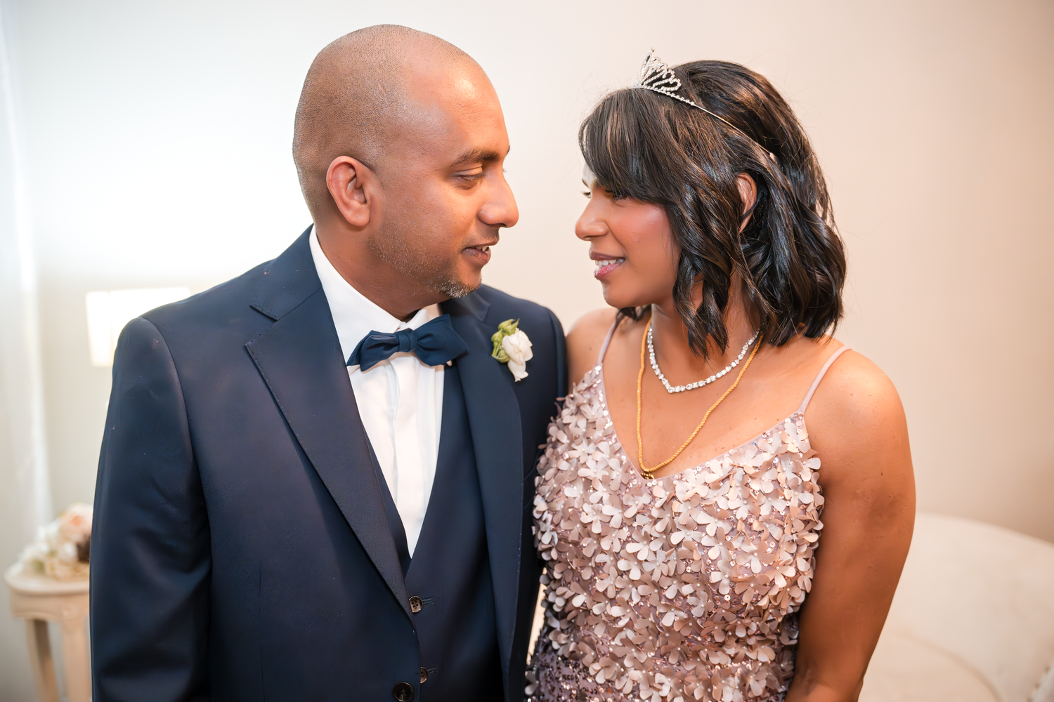 A couple shares an intimate moment in formal attire during their wedding celebration.