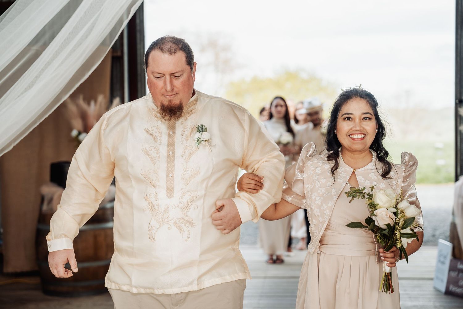 Wedding celebration in a rustic venue with guests and decorative lighting.