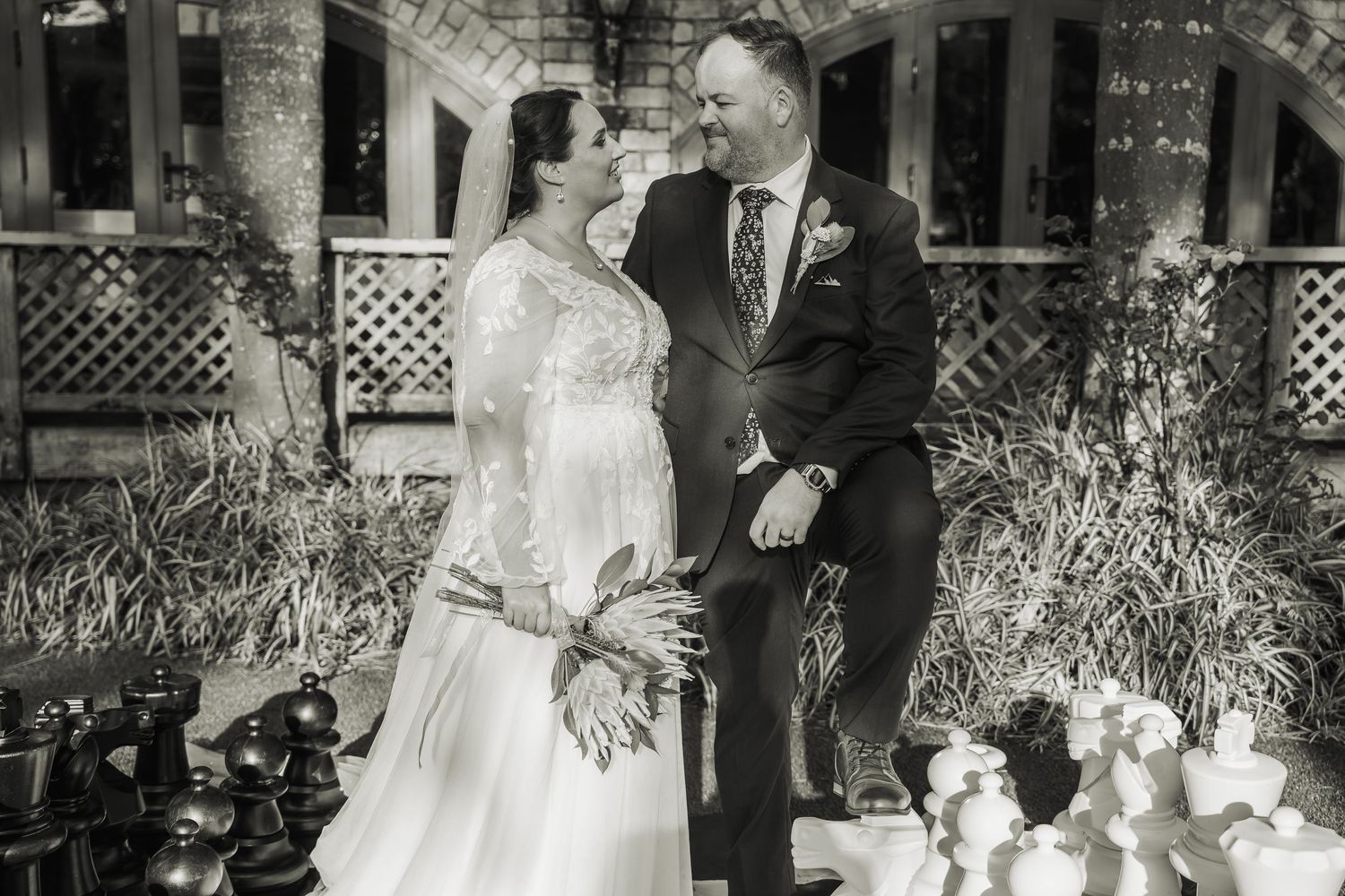 Black and white wedding reception scene with twinkling lights and romantic atmosphere.