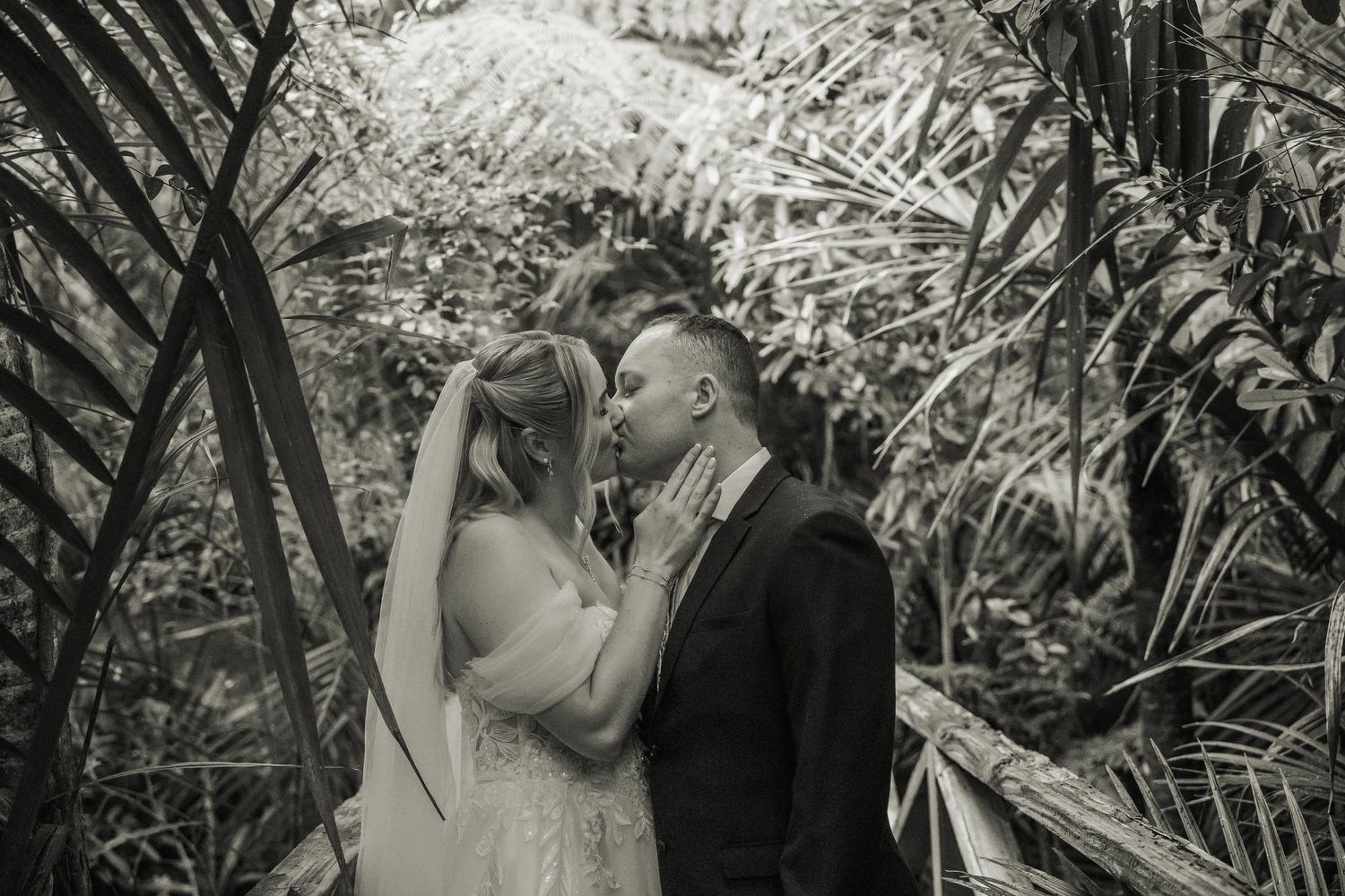 A romantic black and white photo sequence shows a couple embracing in a lush garden setting.