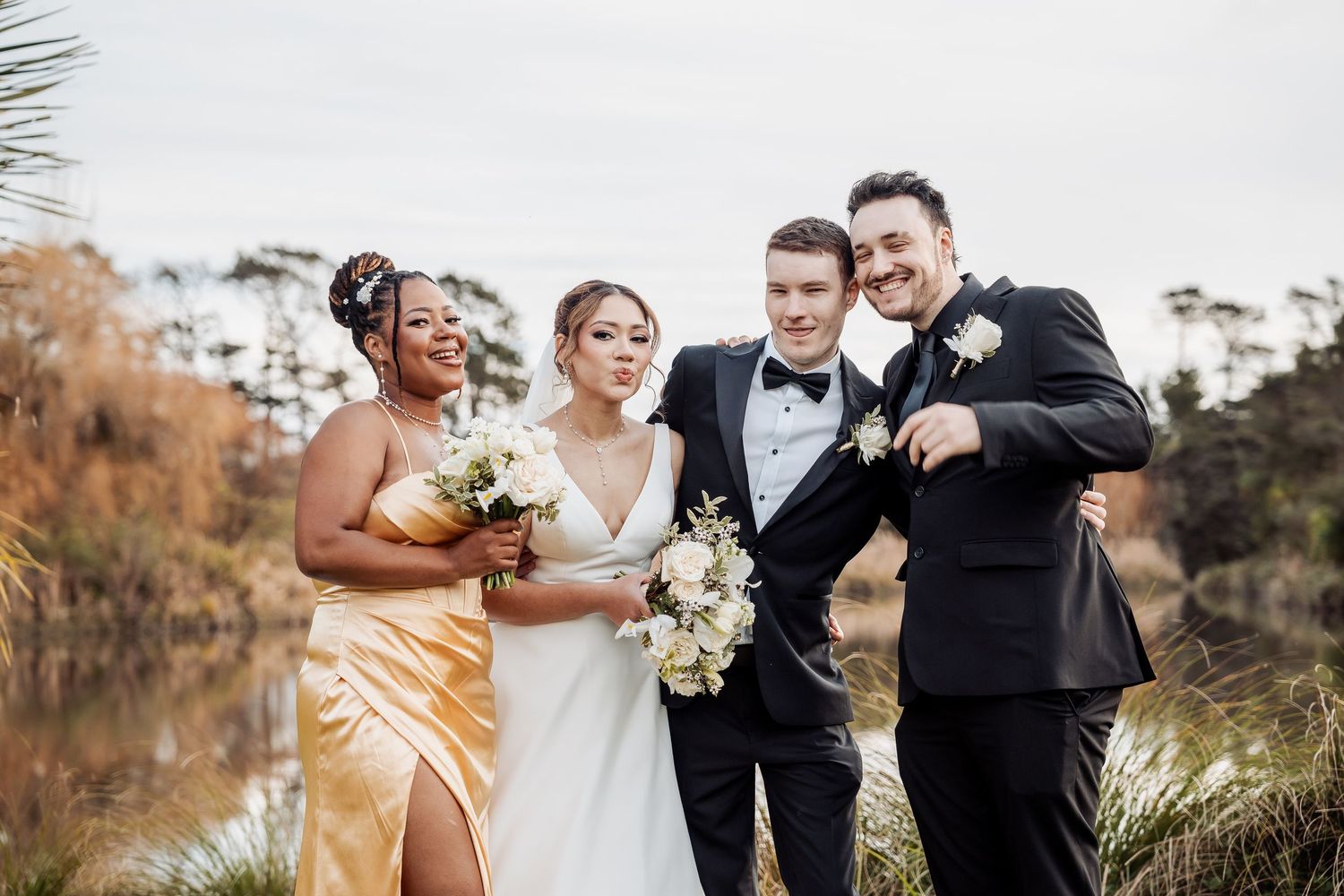 Wedding party celebrates with champagne toasts in an outdoor garden setting.