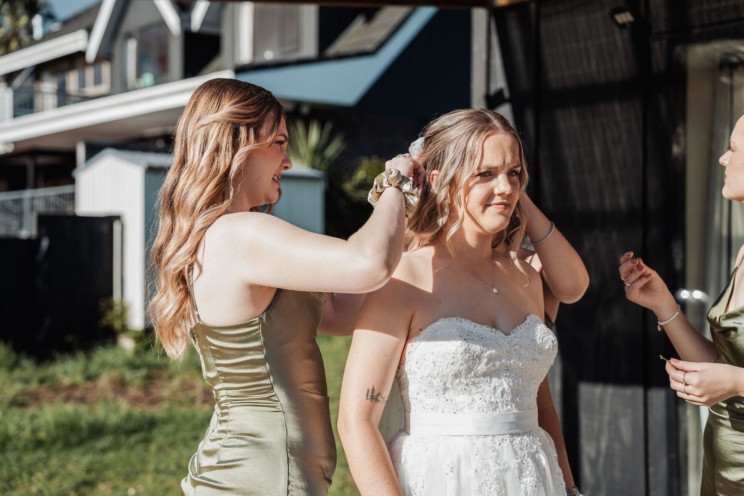 Dancing and celebrating outdoors at a summer wedding reception in front of a rustic barn.