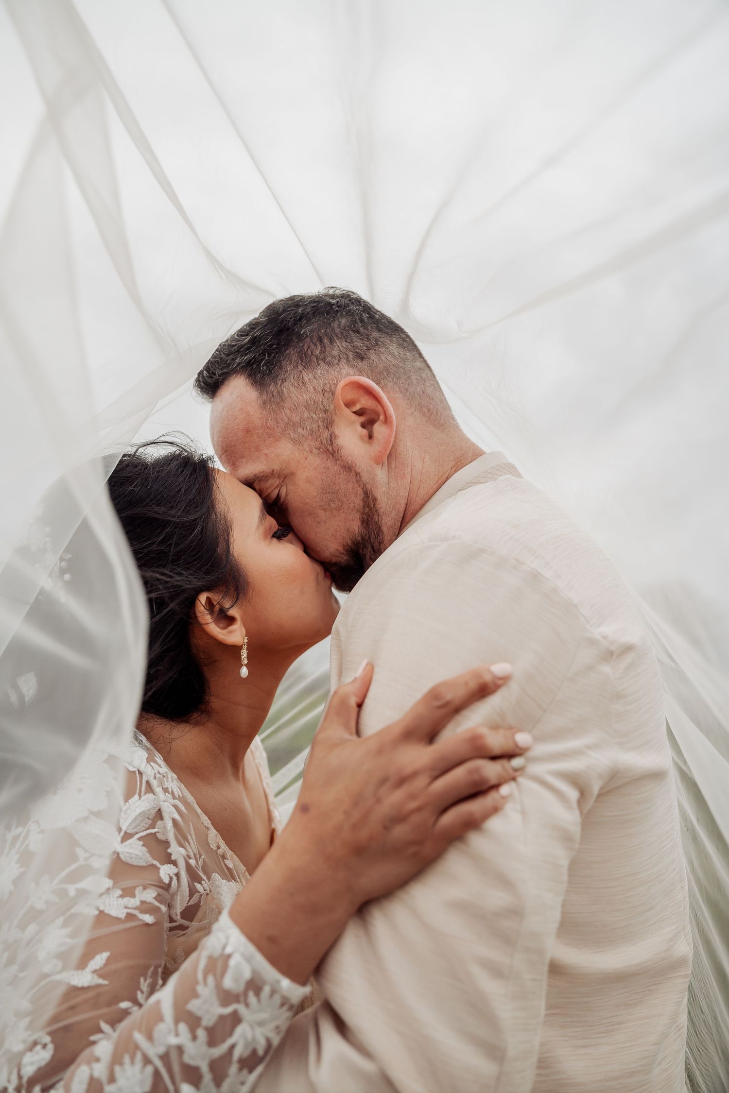 Romantic wedding couple shares intimate moments in a series of close-up shots against a white backdrop.