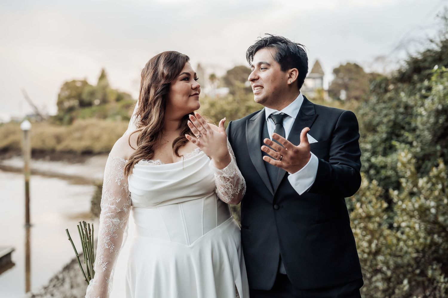 Couple in formal wedding attire share intimate moments while posing together outdoors.